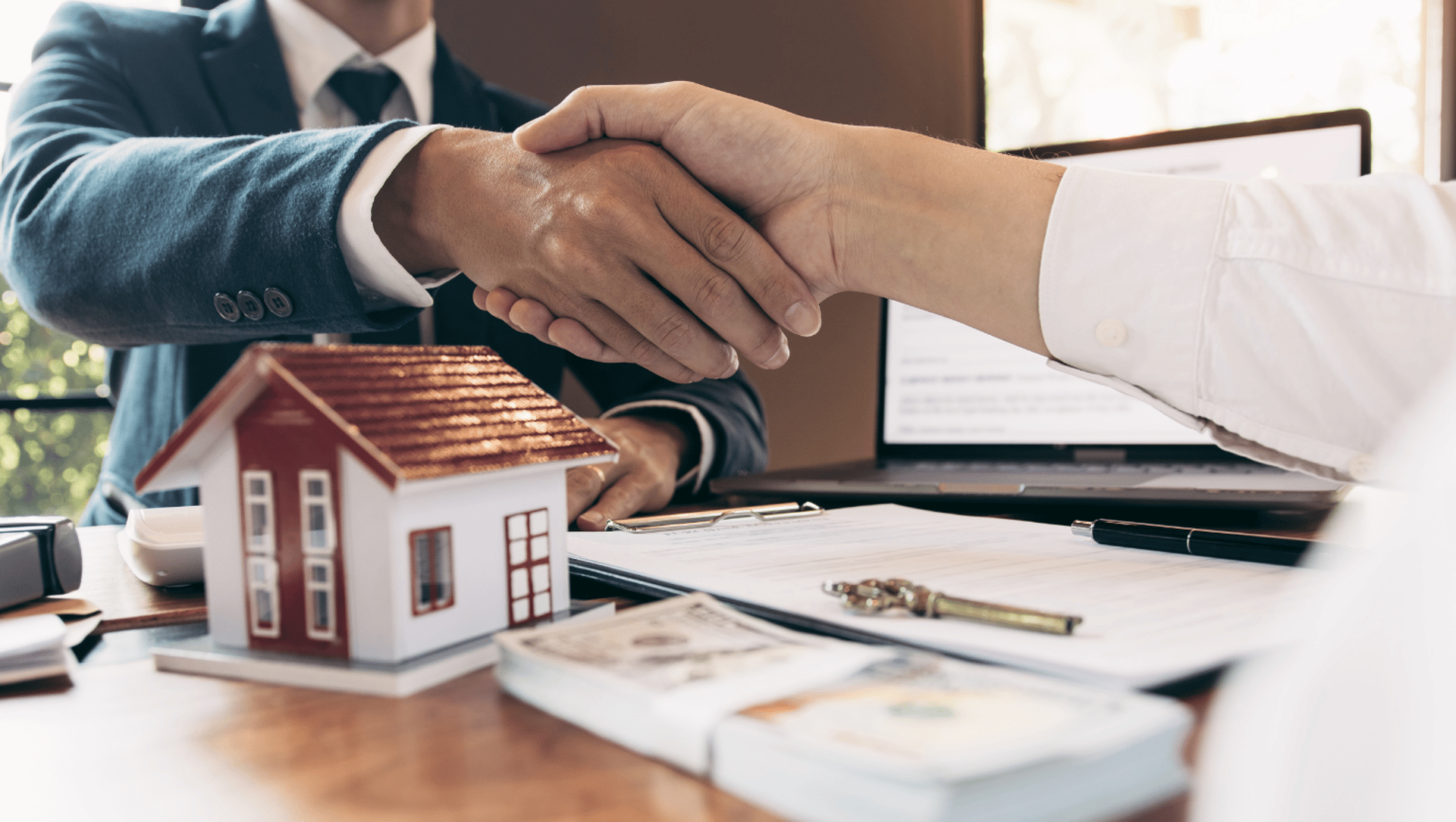 Deux personnes se serrant la main, symbole de partenariat profitable entre acheteur, vendeur et expert en transaction hôteliè