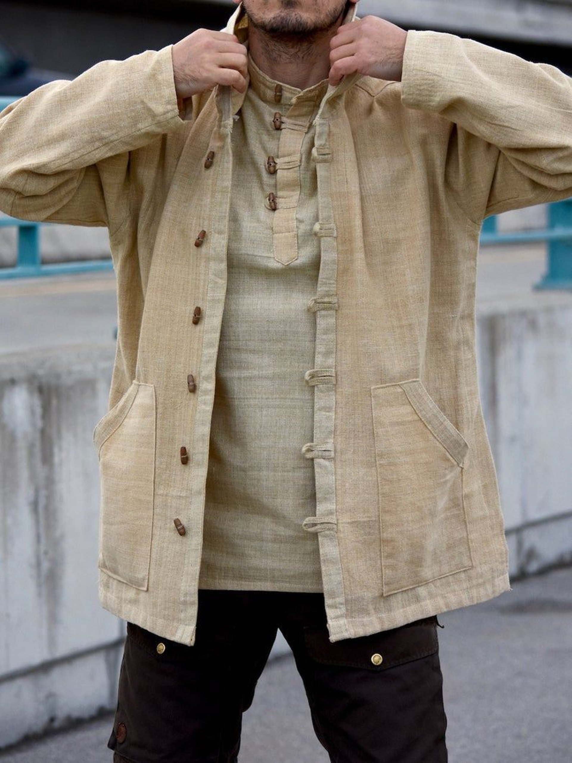 A woman in a green dress standing in front of a bamboo forest