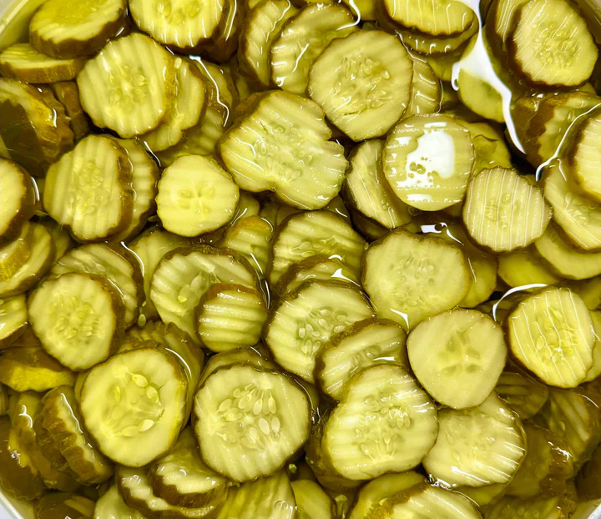 3 green cucumbers on black wooden table