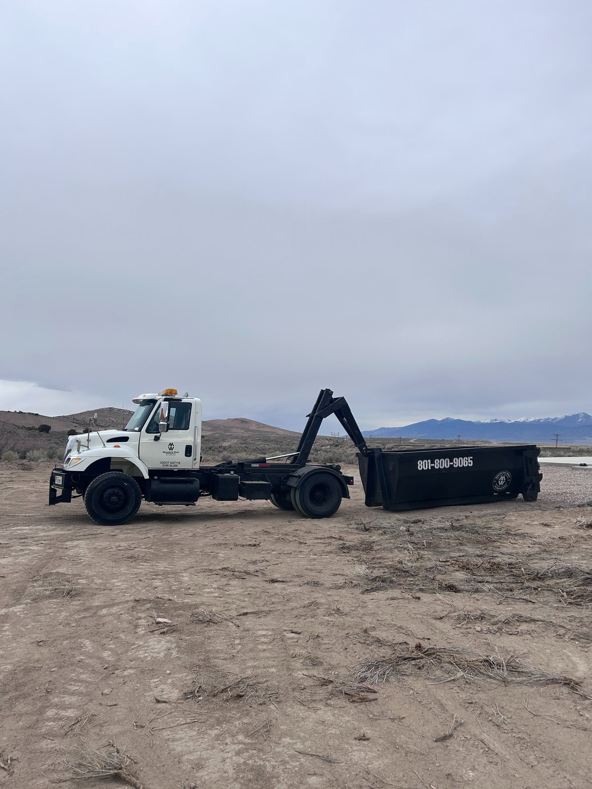 an aerial view of a dirt field with a truck