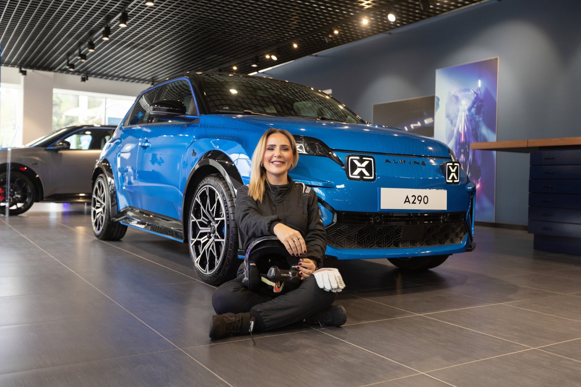 man in white shirt standing beside black car