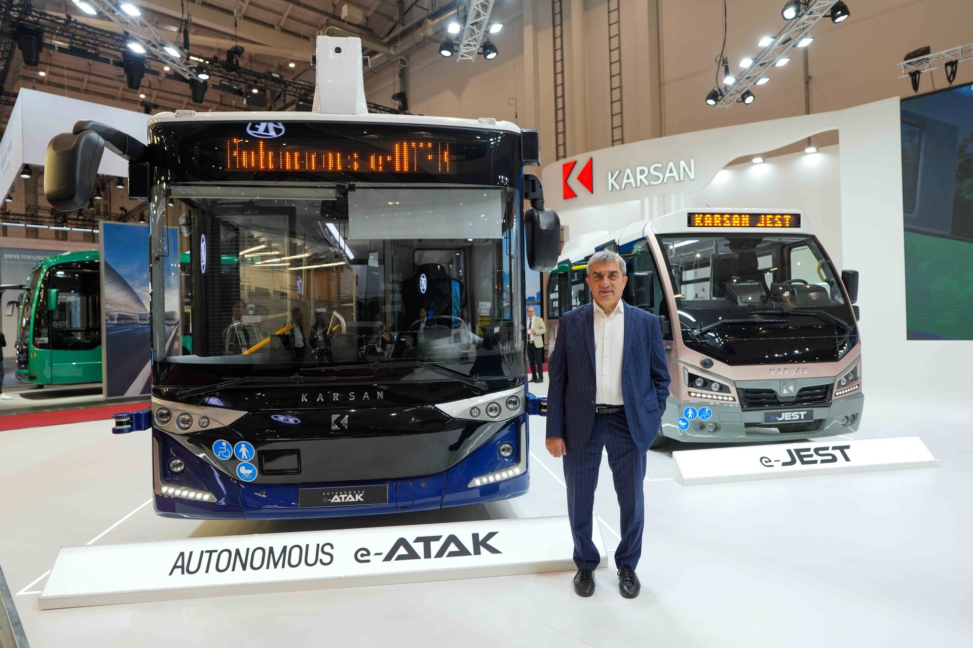 man in white shirt standing beside black car