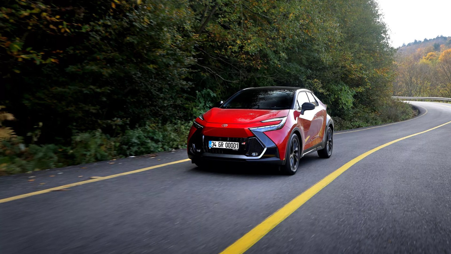 man in white shirt standing beside black car