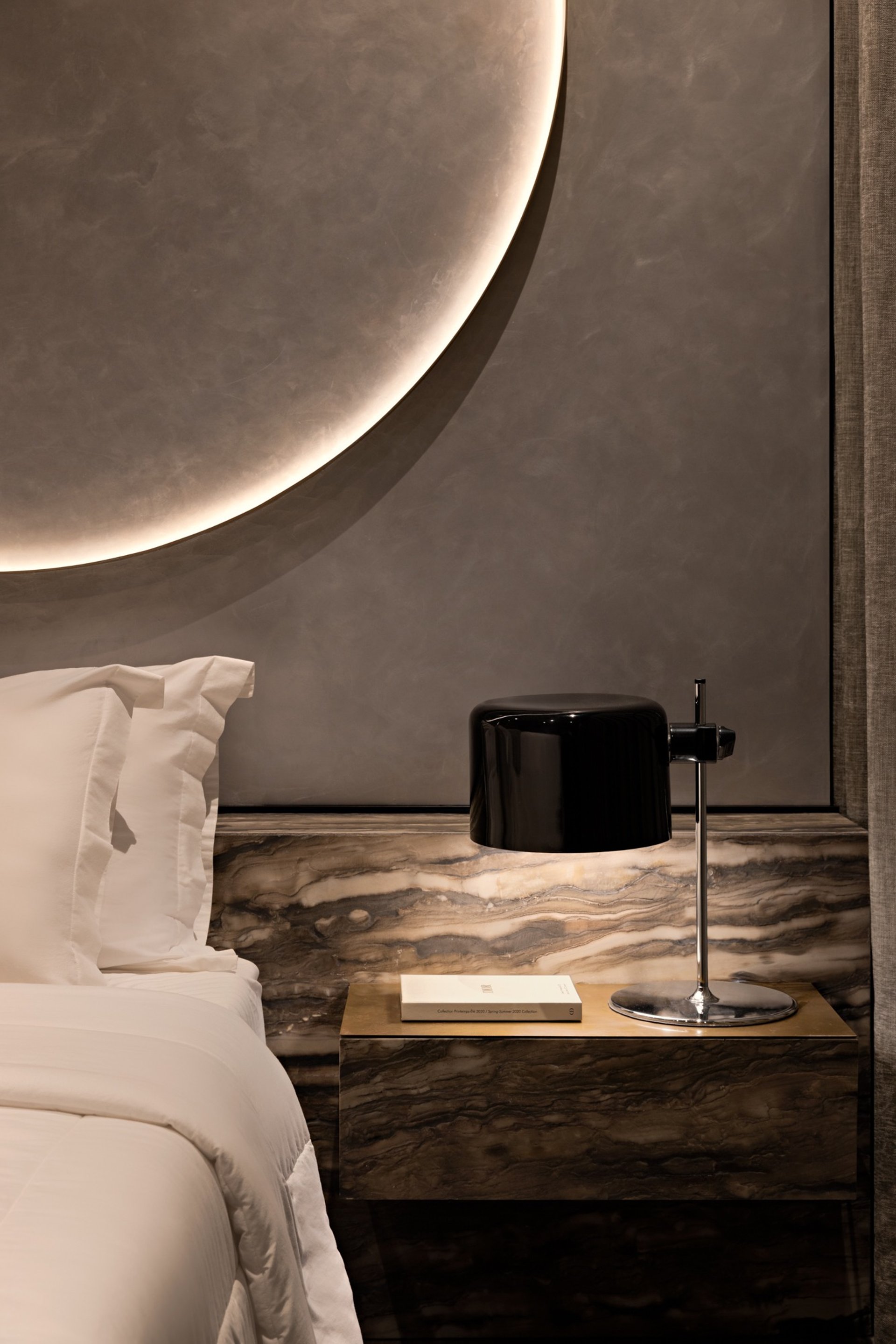 an abstract photo of a curved building with a blue sky in the background