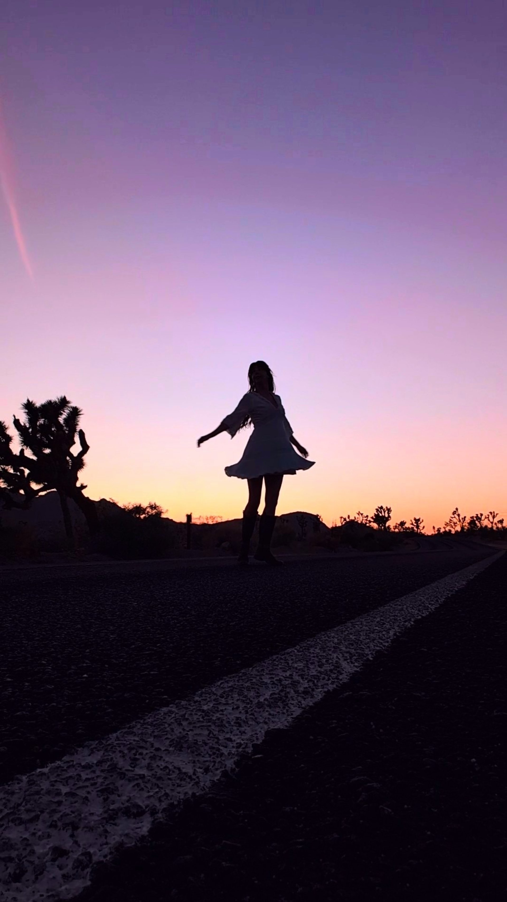 a woman standing in a room next to a chair