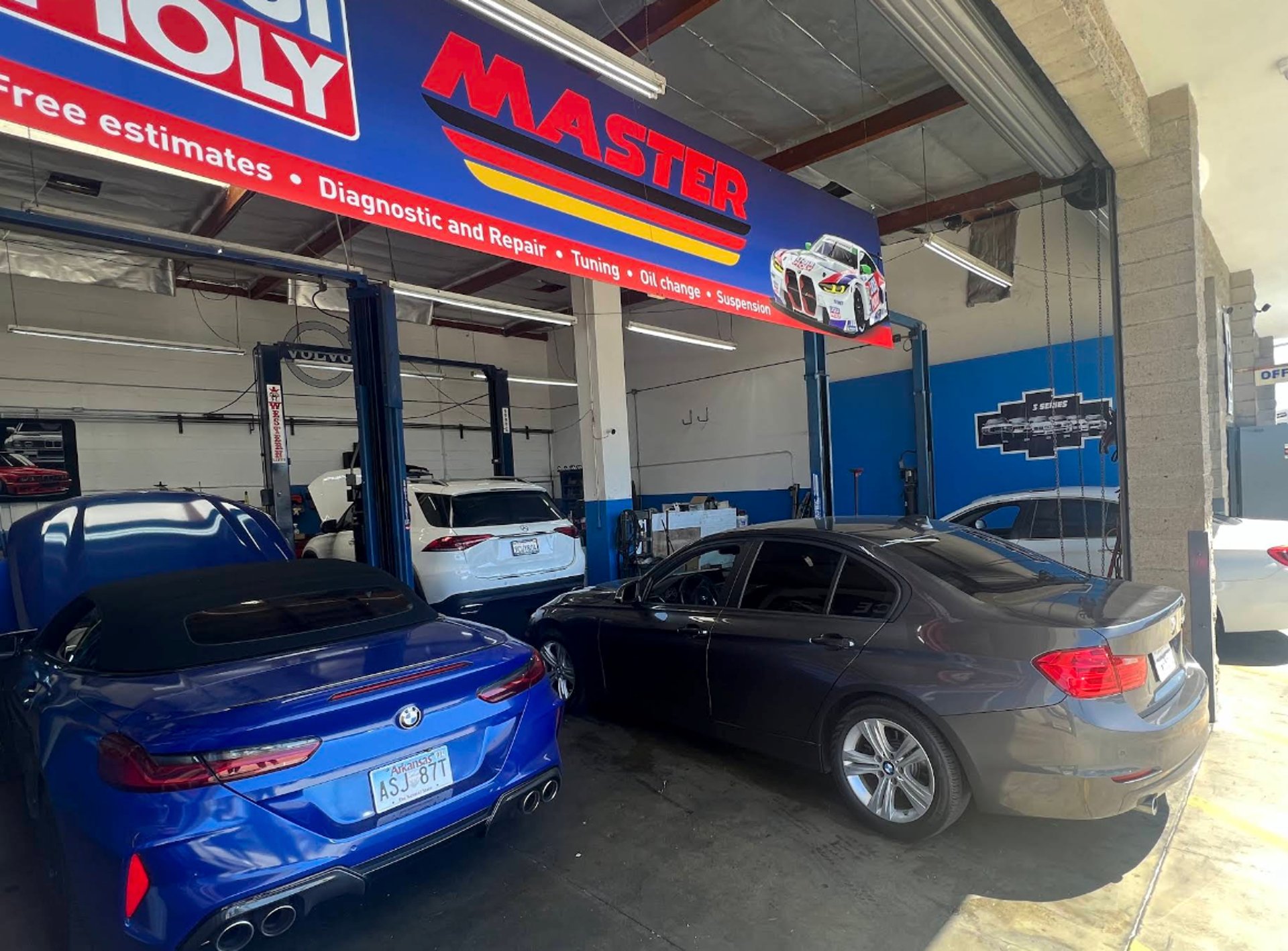 a couple of cars that are parked in a garage