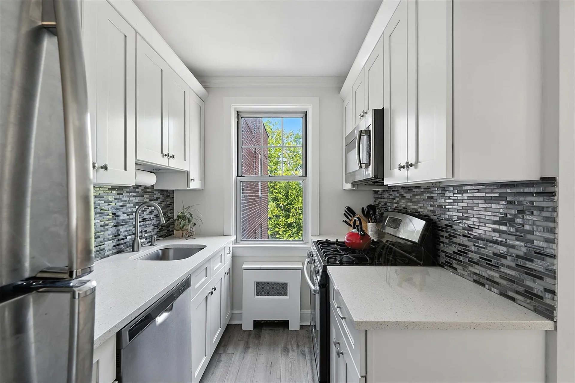 A beautiful kitchen has wooden cabinets and stainless steel.