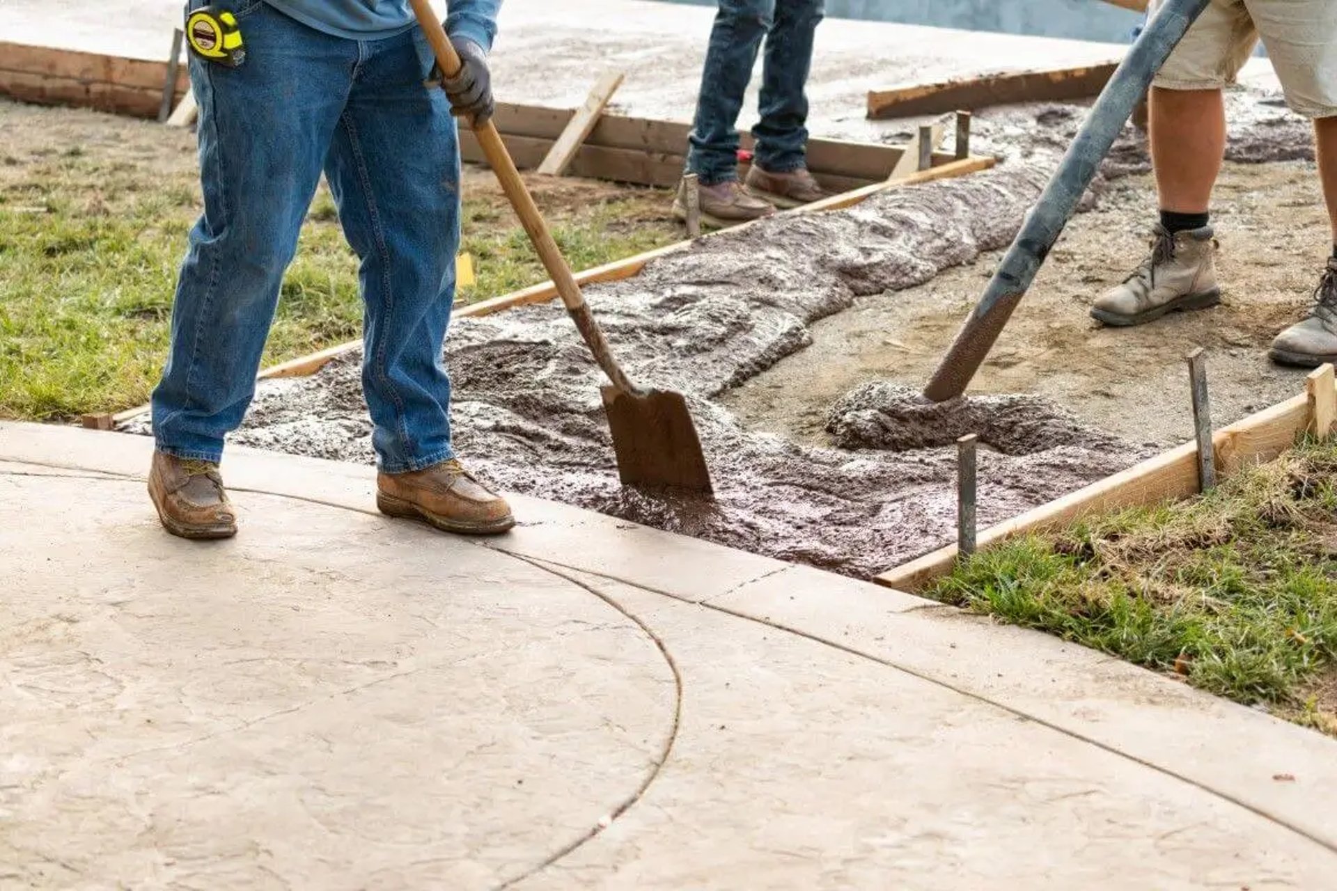 Men installing concrete sidewalk