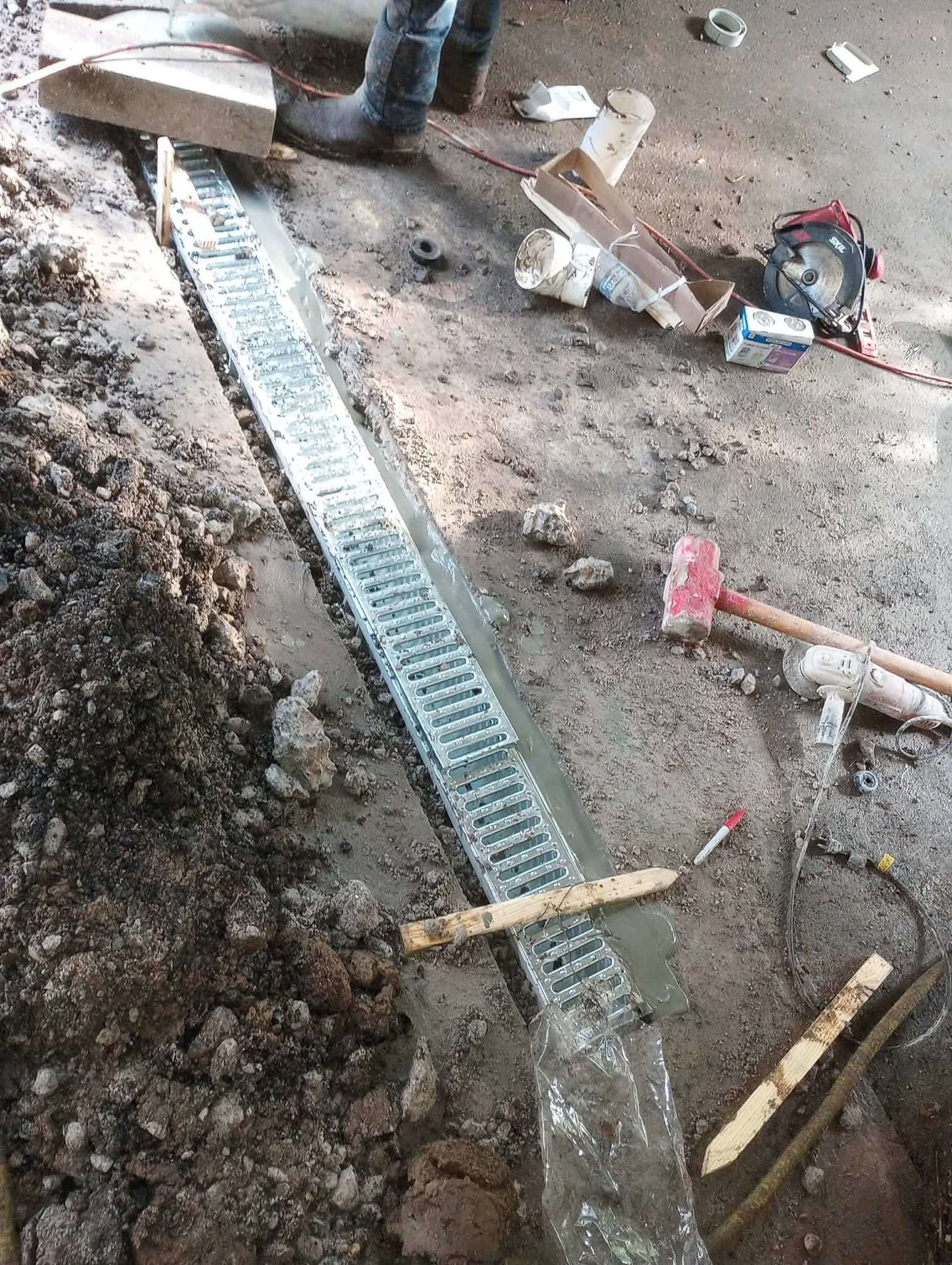 french drain in concrete garage.
