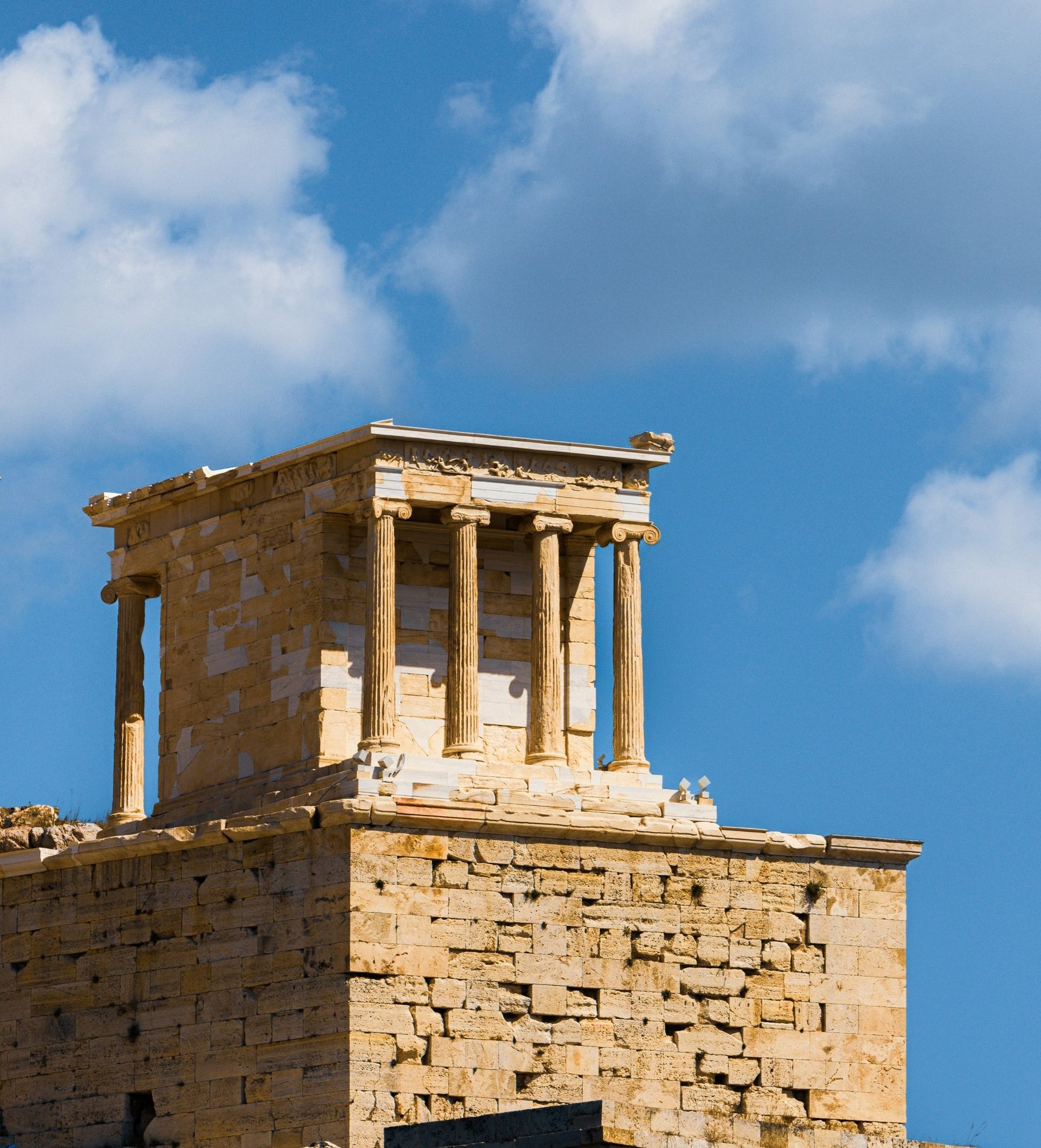 an abstract photo of a curved building with a blue sky in the background