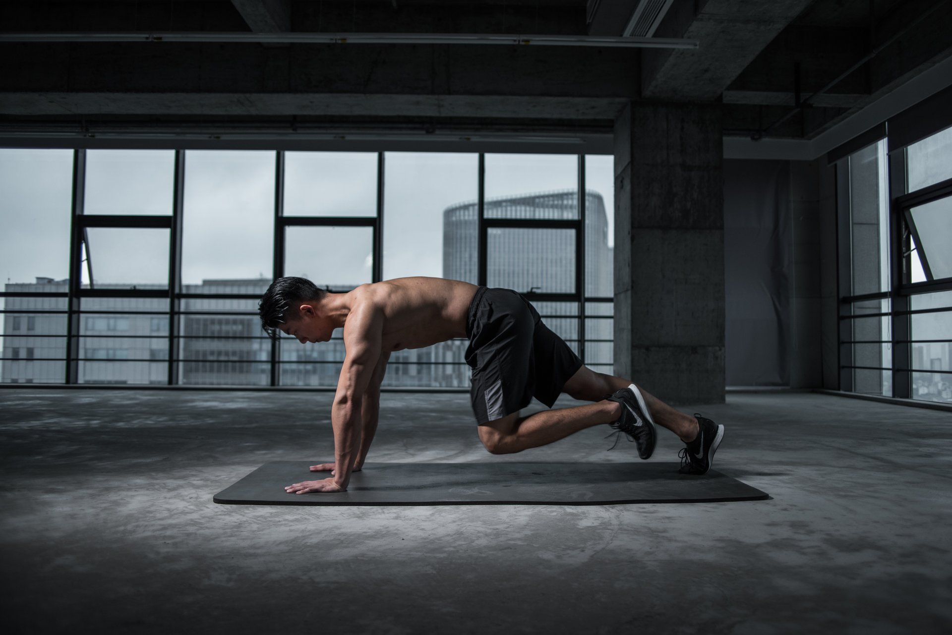 grayscale photo of man working out