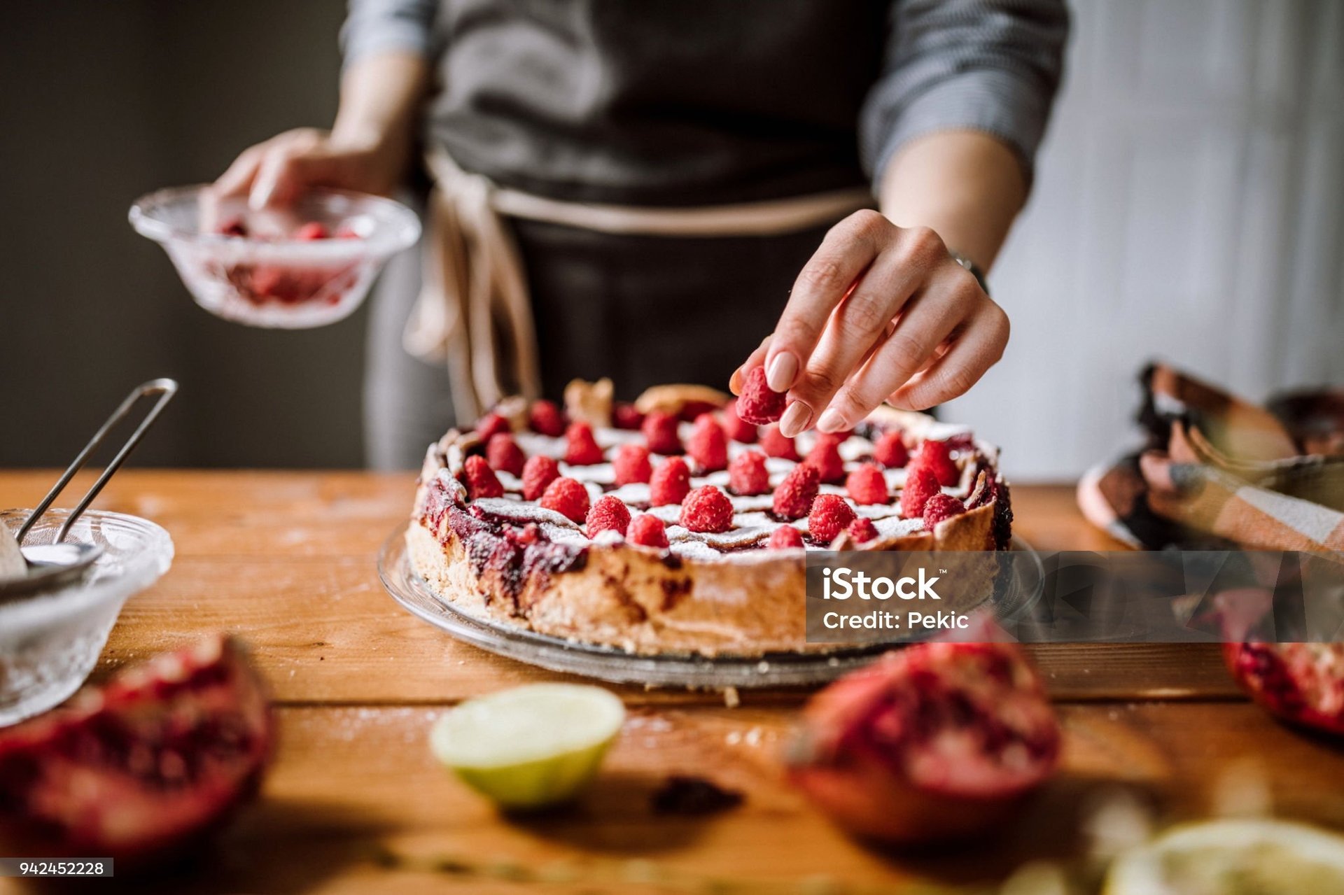 person pouring chocolate powder on cake