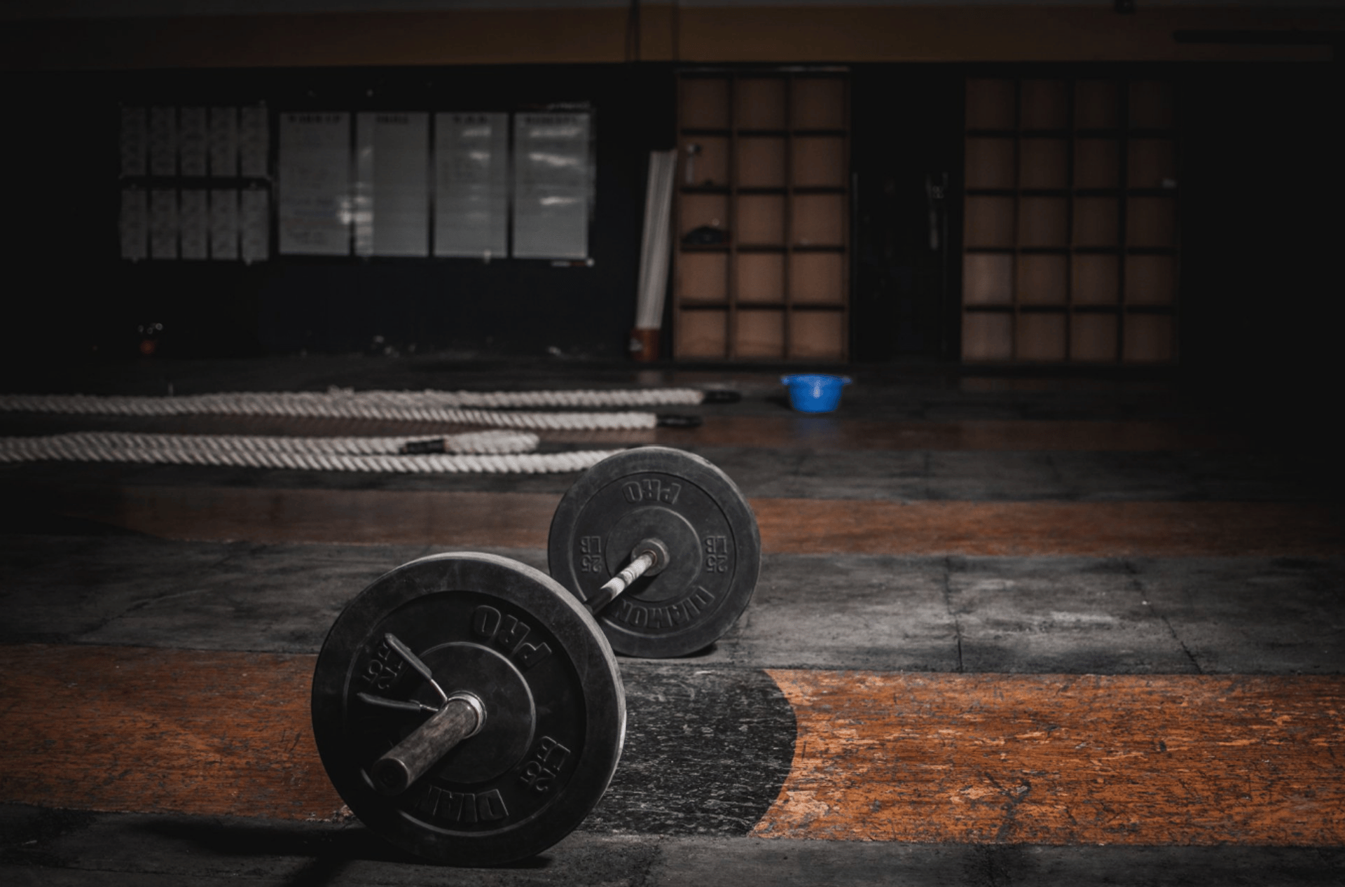 black barbell on tile flooring