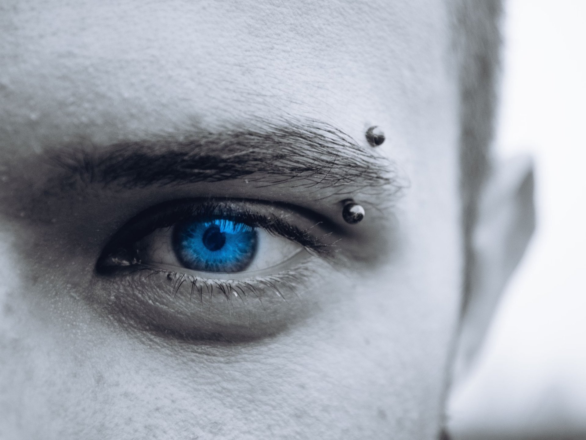 selective photo of man's blue eye