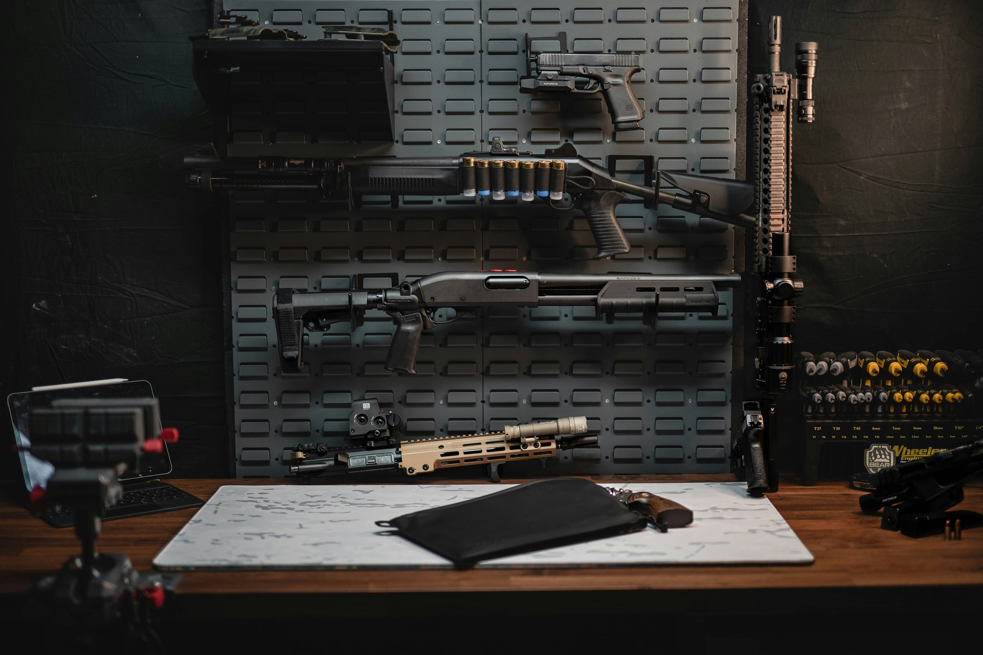 a rifle on a table next to other items