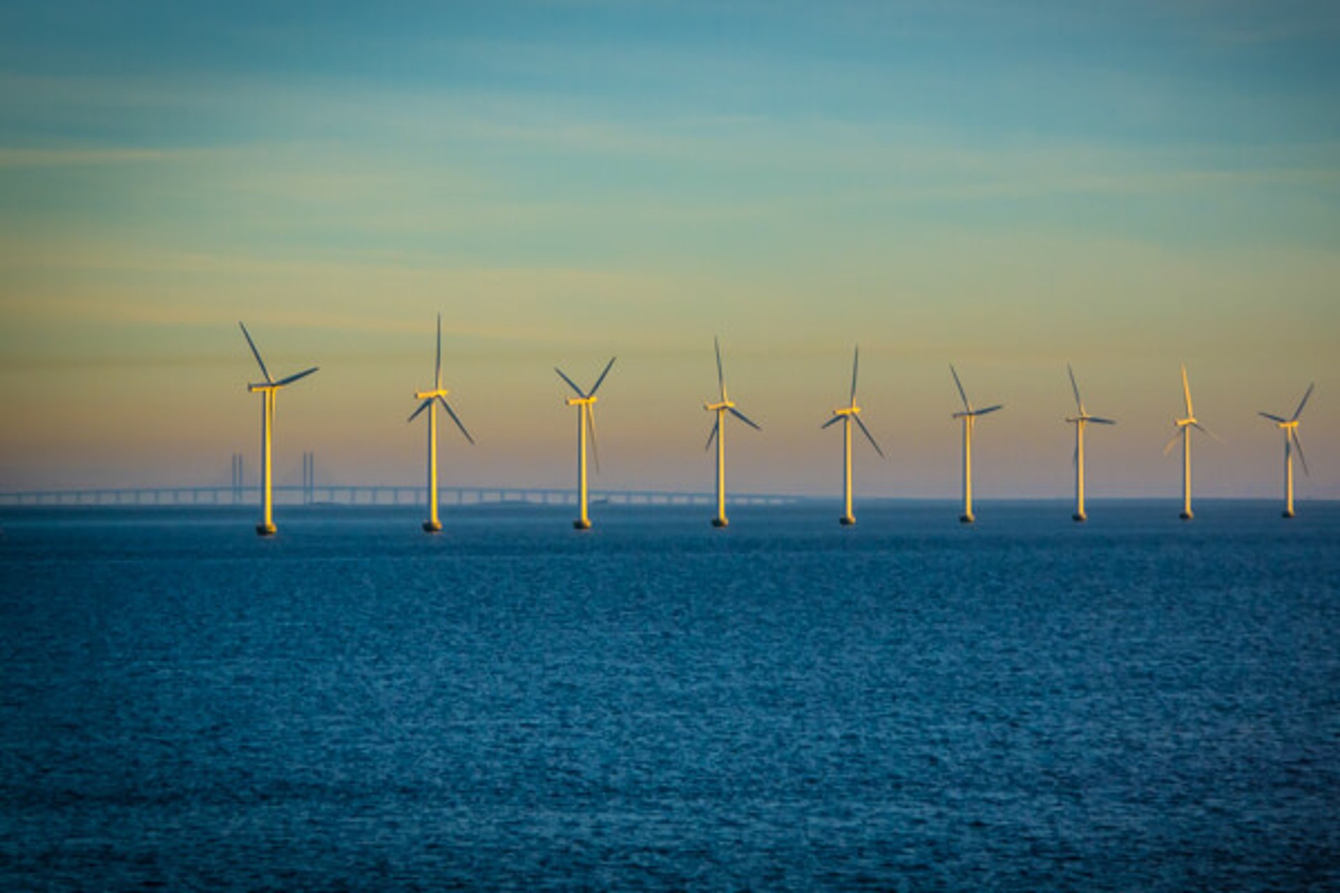 an abstract photo of a curved building with a blue sky in the background