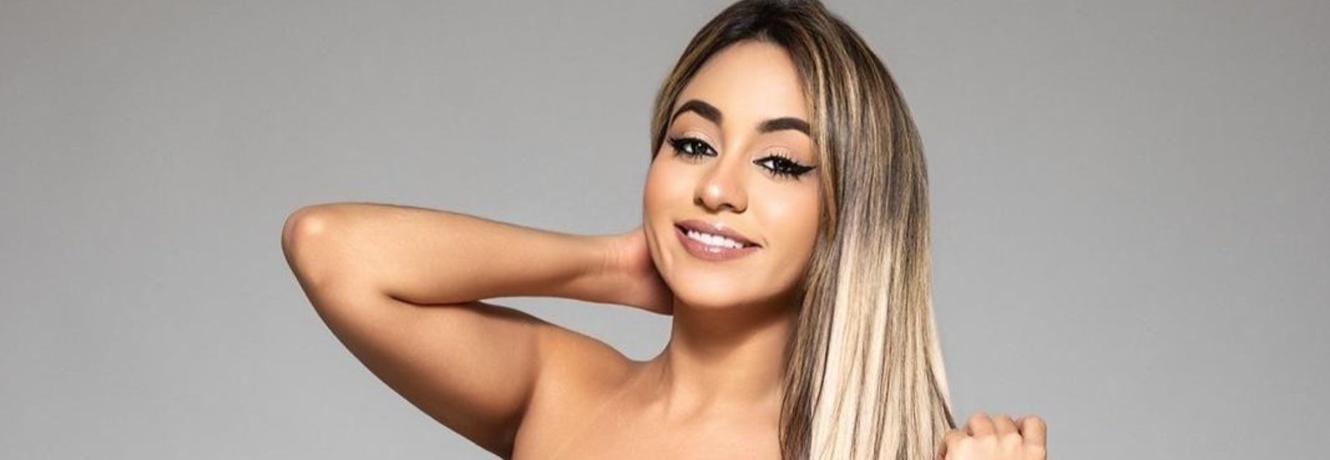 a woman in a black lingerie sitting on a bed