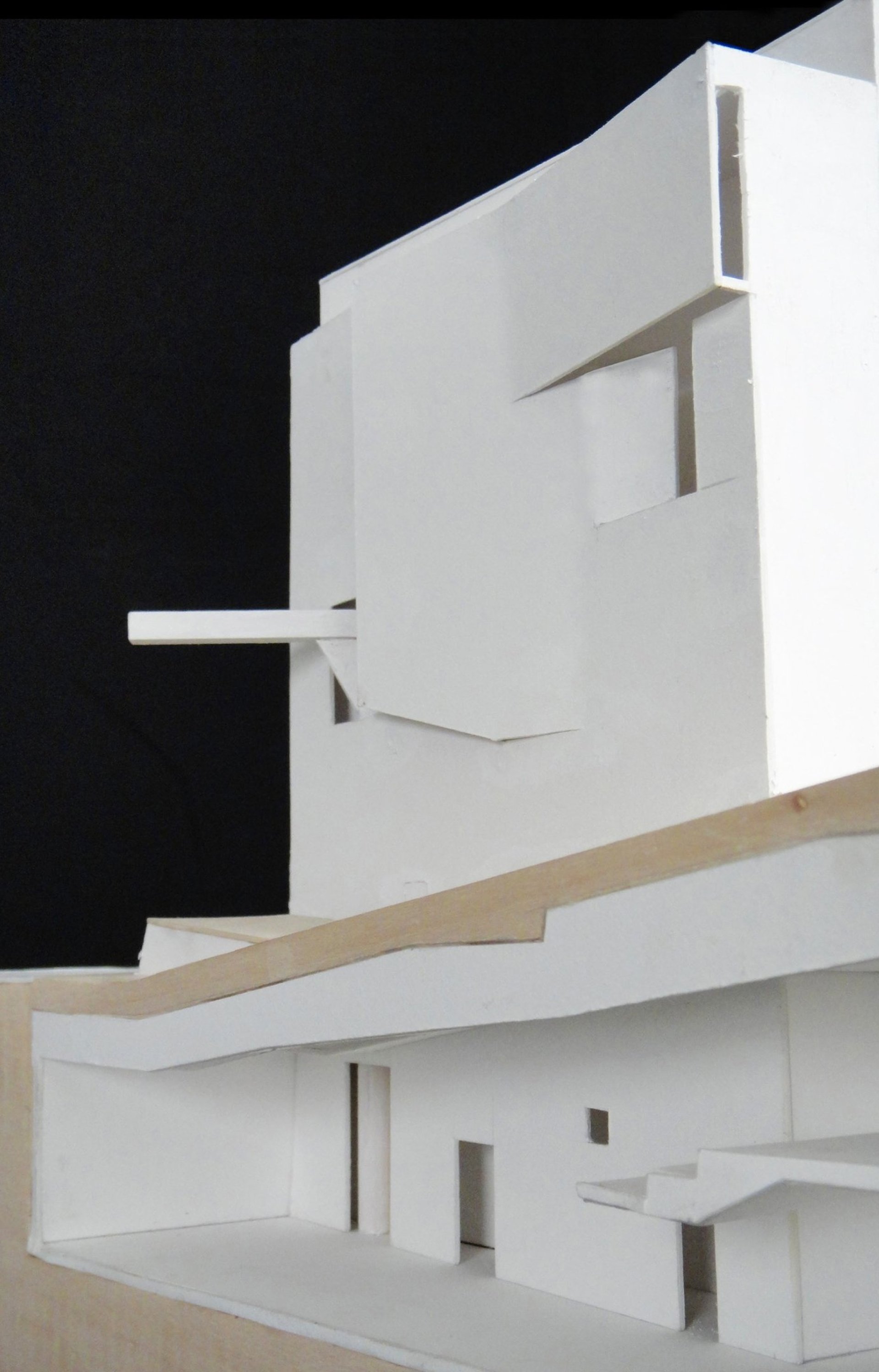 an abstract photo of a curved building with a blue sky in the background