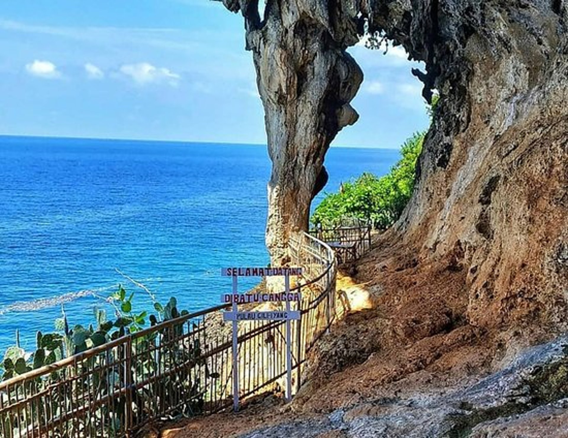 woman wearing yellow long-sleeved dress under white clouds and blue sky during daytime