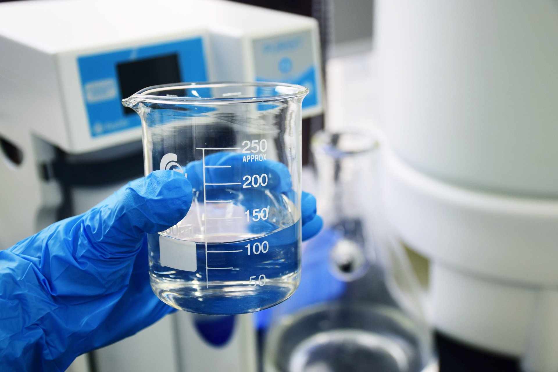 three clear beakers placed on tabletop