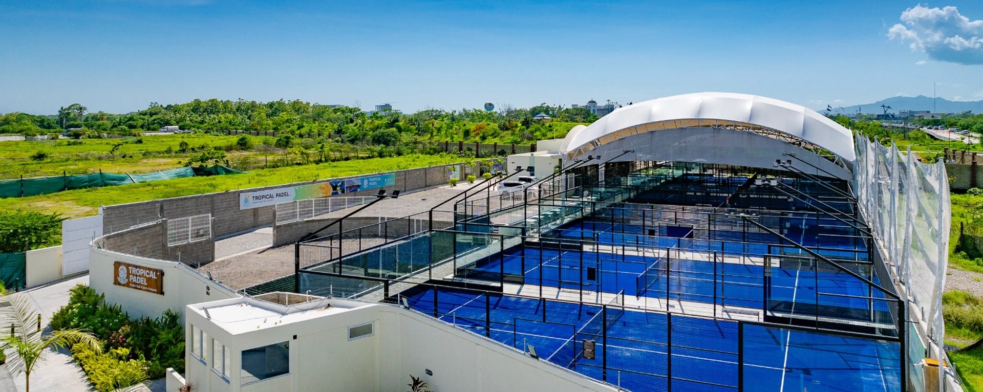 an abstract photo of a curved building with a blue sky in the background