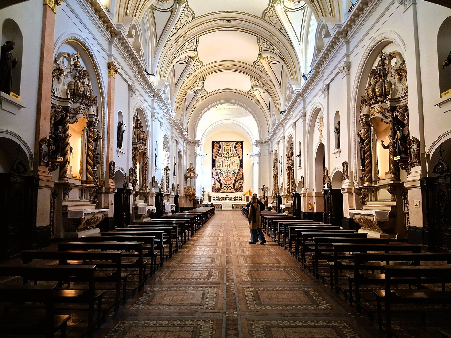 an abstract photo of a curved building with a blue sky in the background