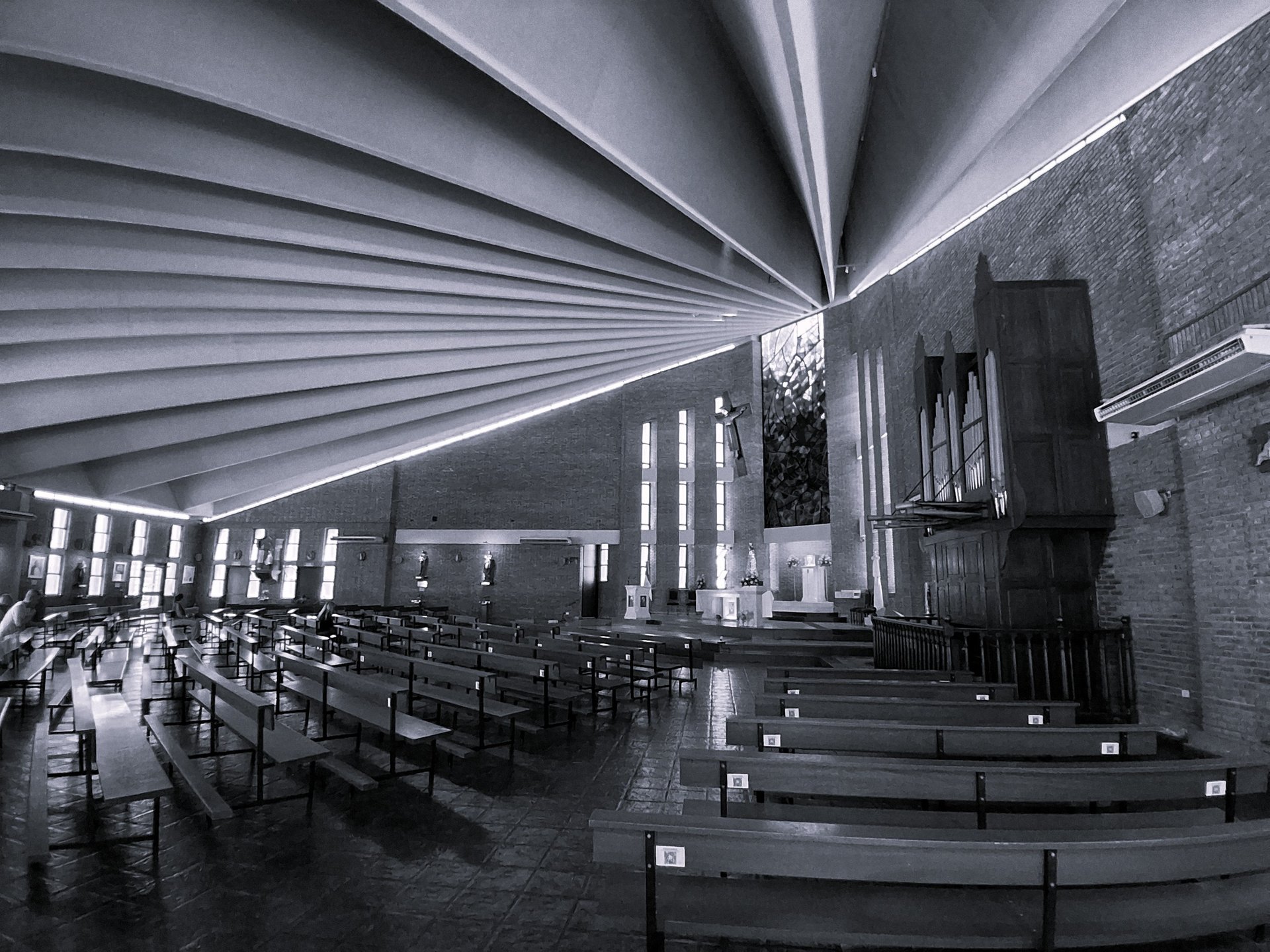 an abstract photo of a curved building with a blue sky in the background