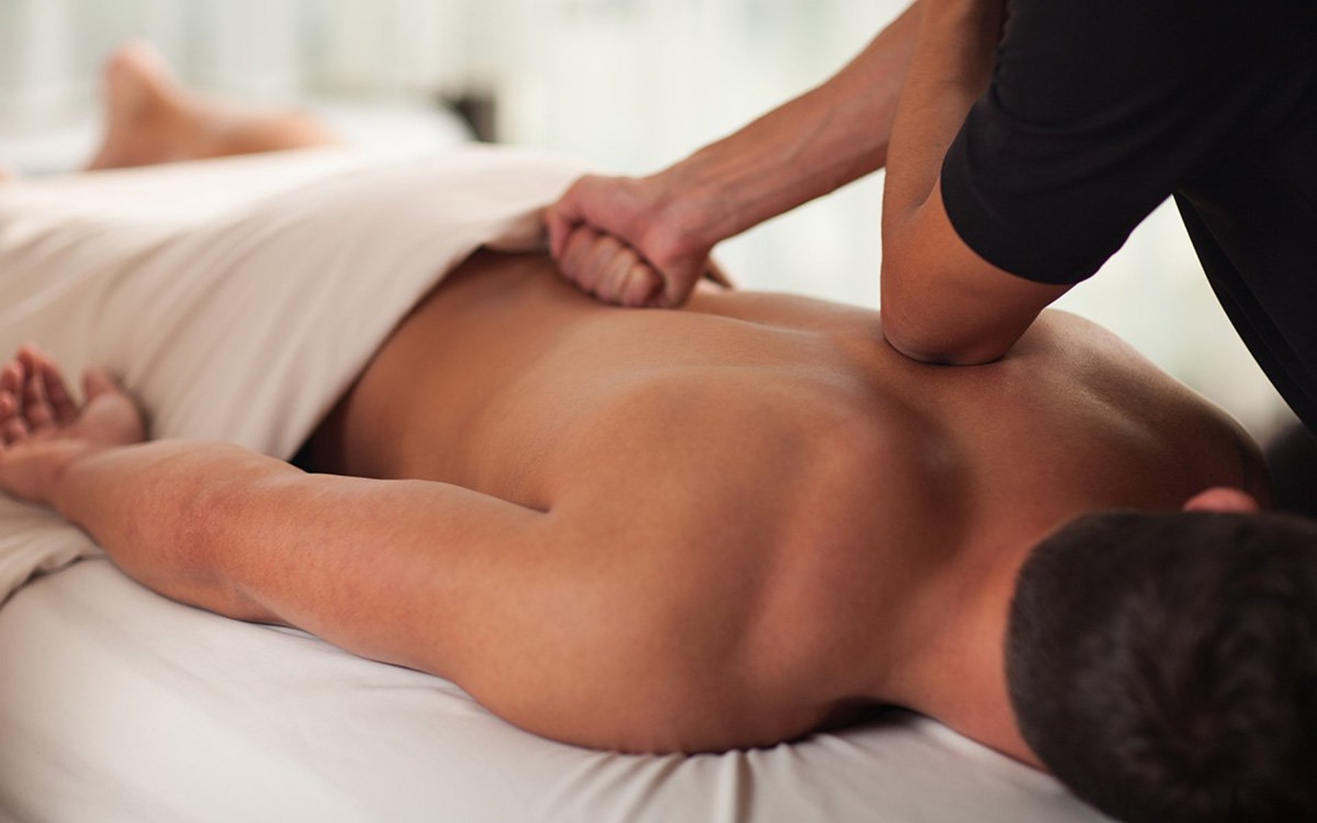 a woman getting a back massage from a man