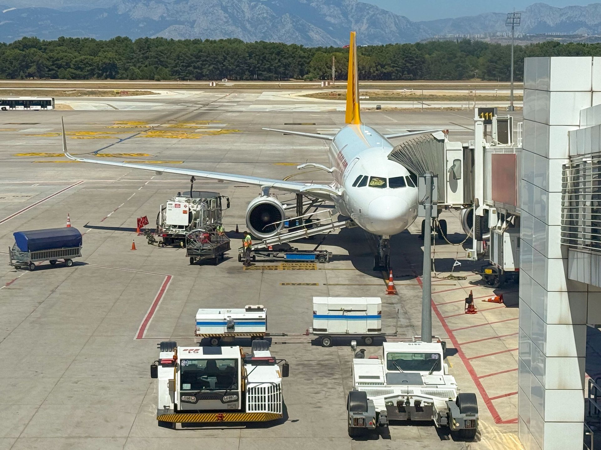 Airplanes are parked at a busy airport terminal.
