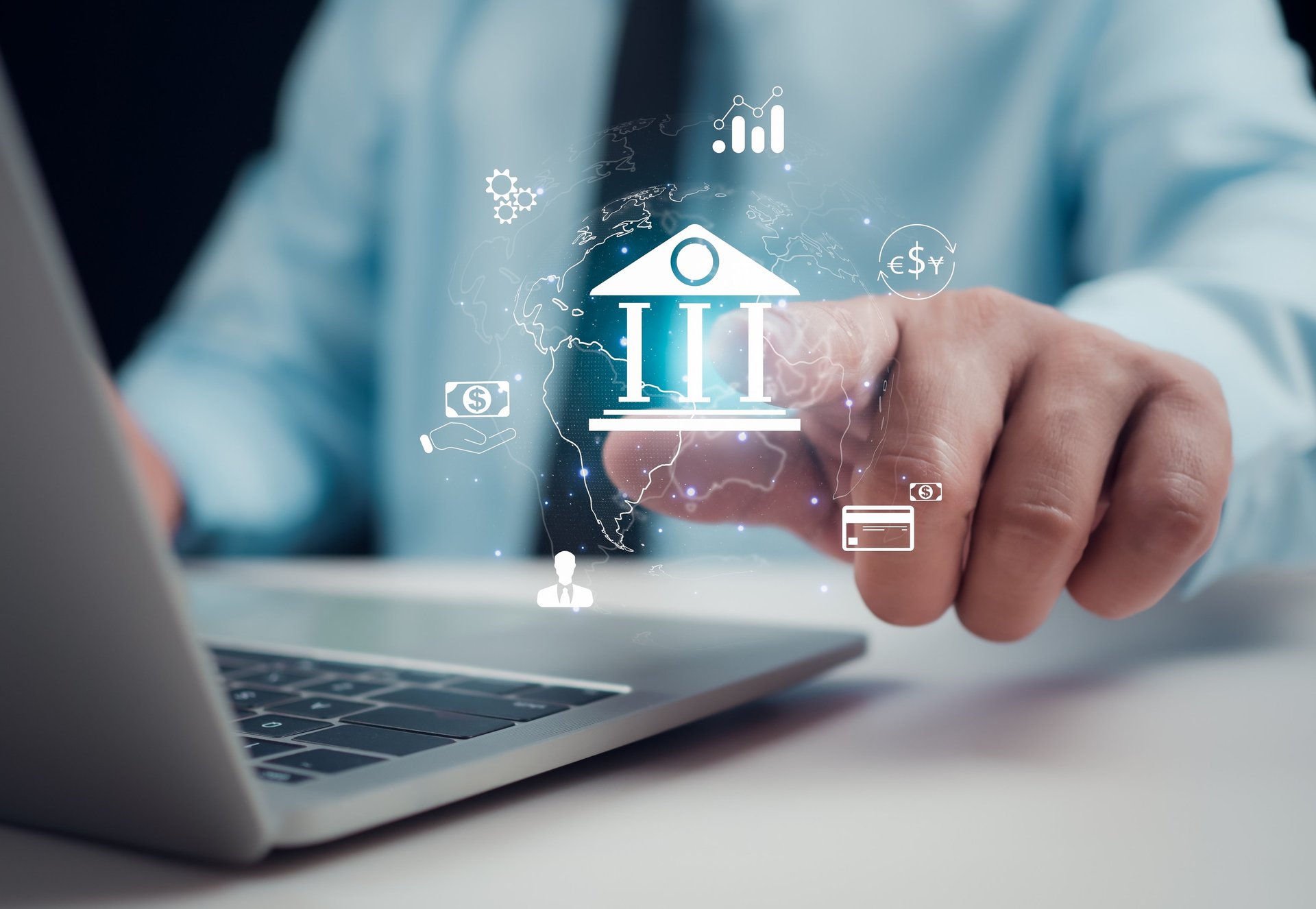 a woman sitting at a desk looking at a computer screen