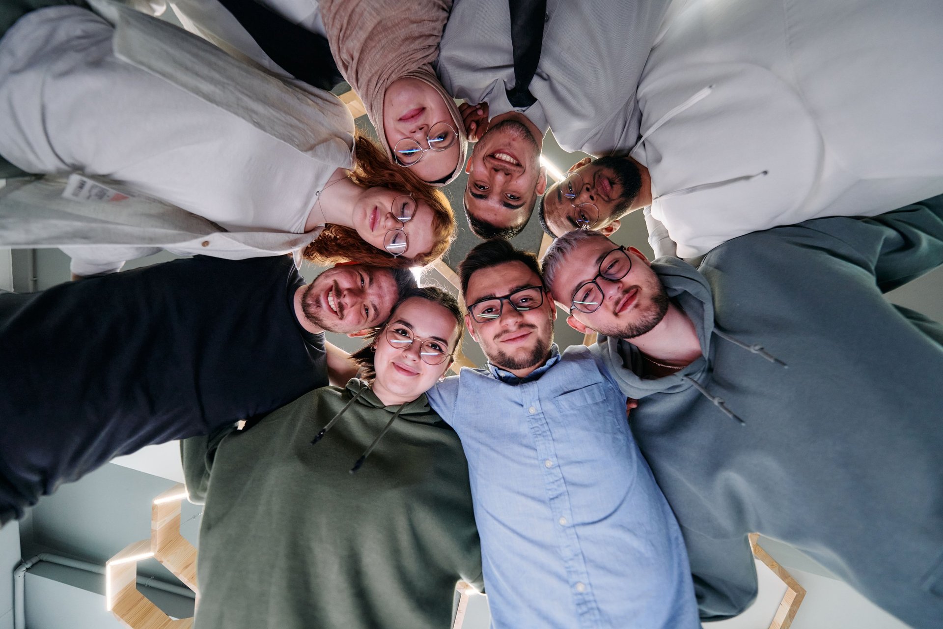 a person writing on a piece of paper next to a computer monitor