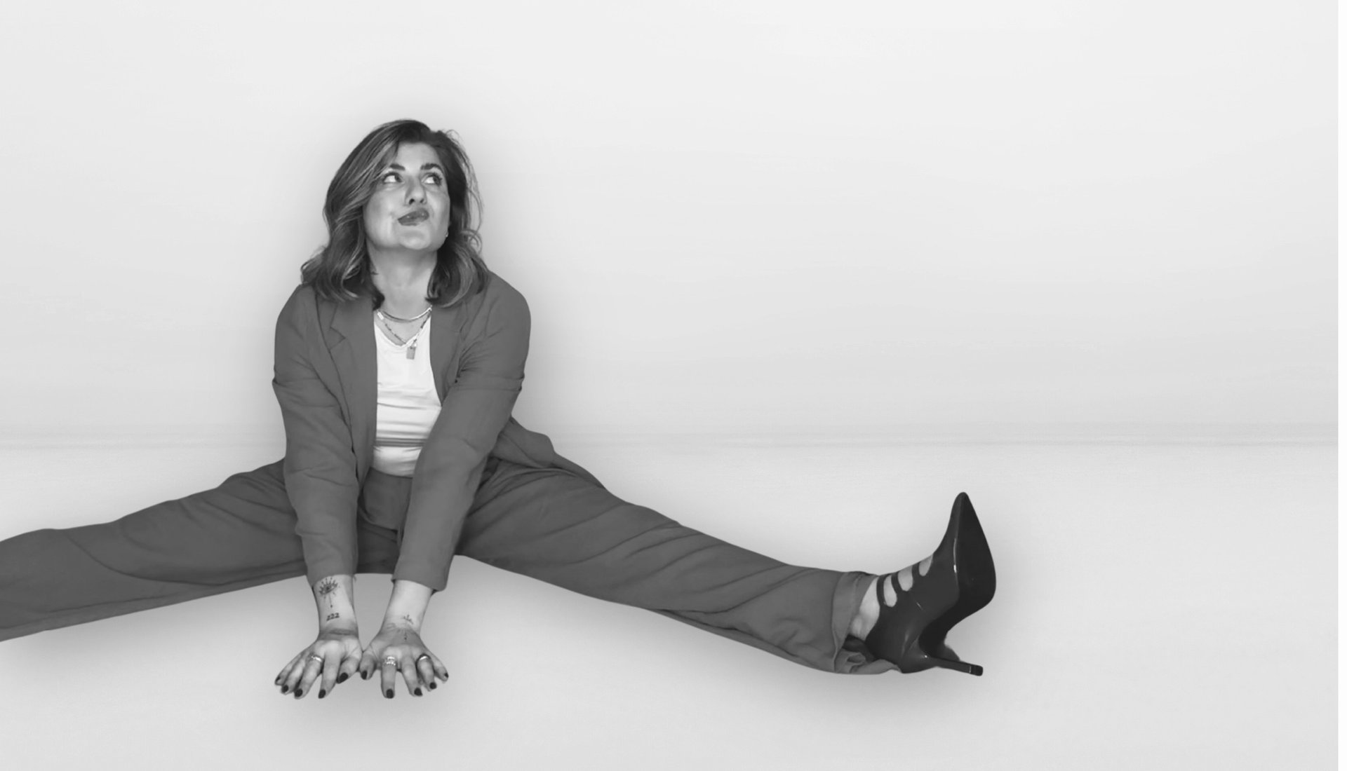 a woman sitting on the ground next to a chair
