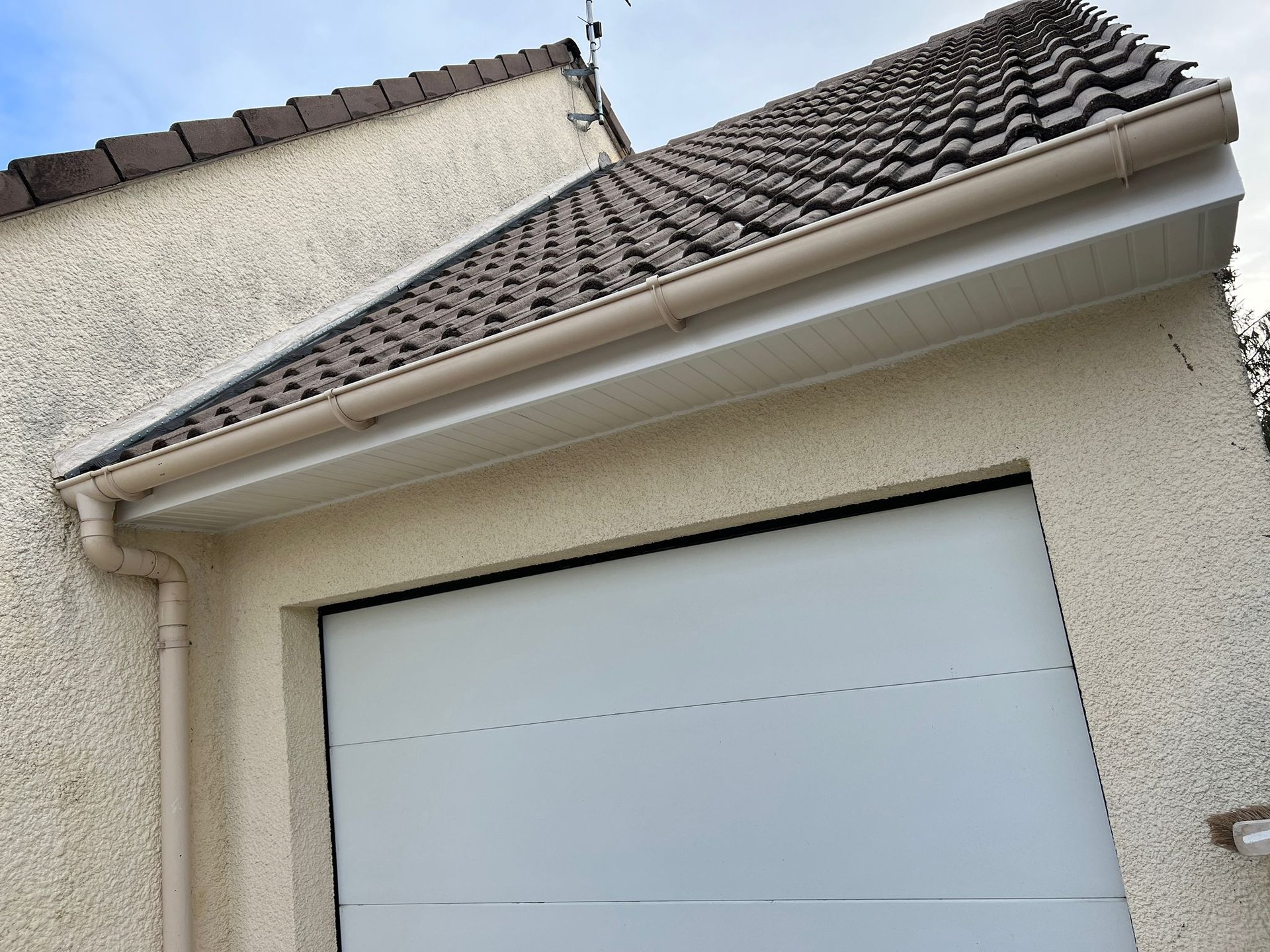 person in blue pants sitting on brown wooden floor