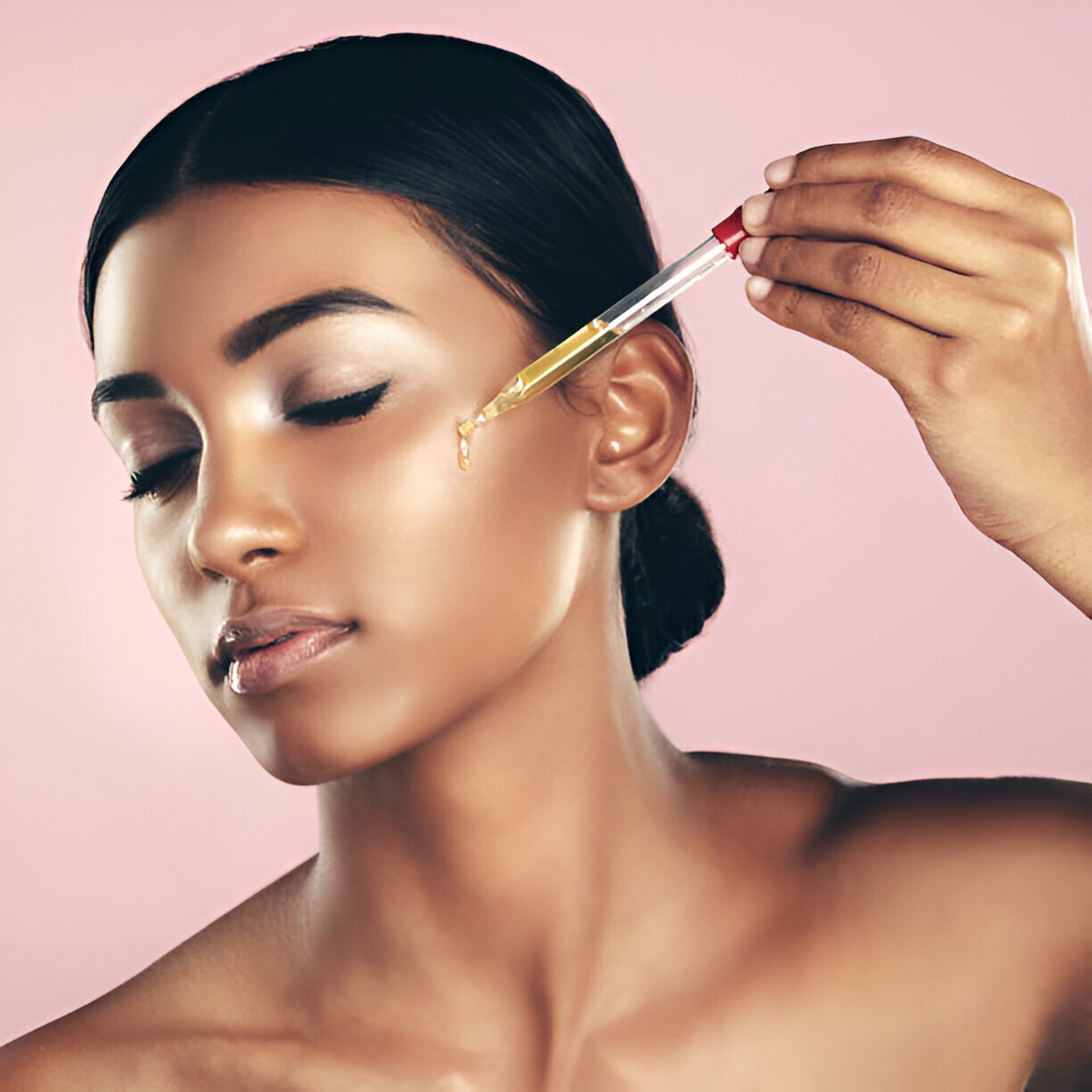 woman staring directly at camera near pink wall