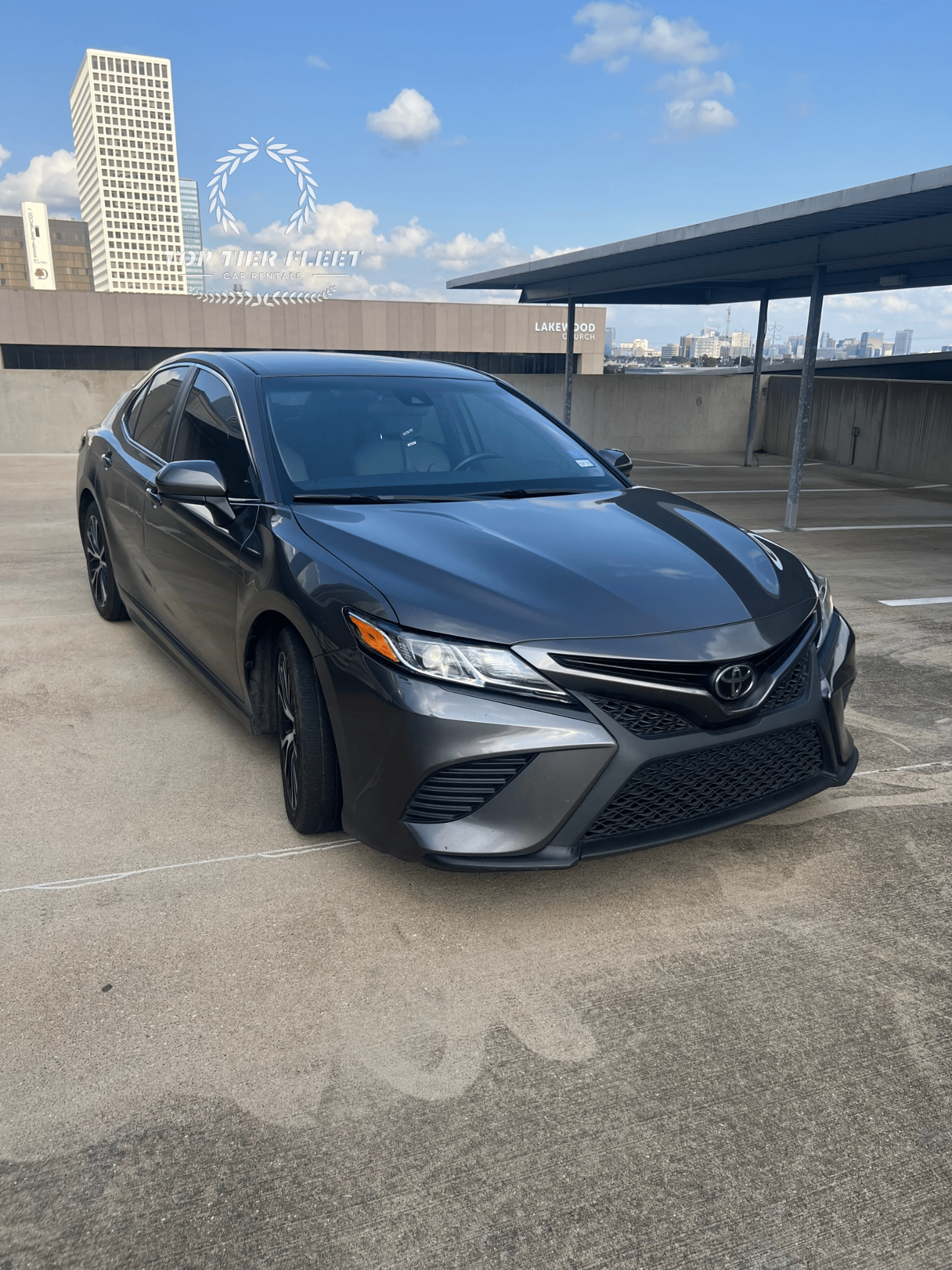 silver sedan parked on road during daytime