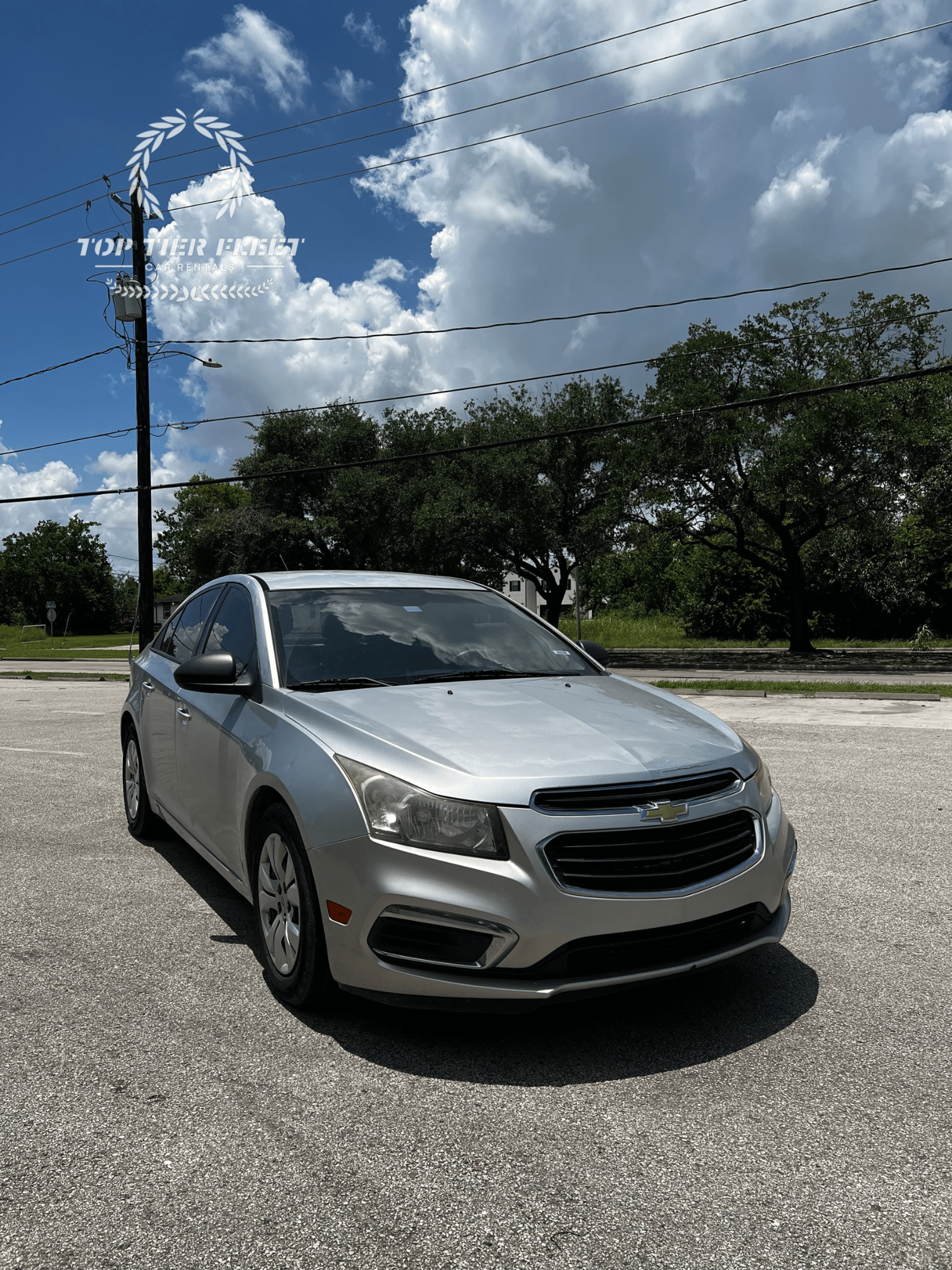 silver sedan parked on road during daytime