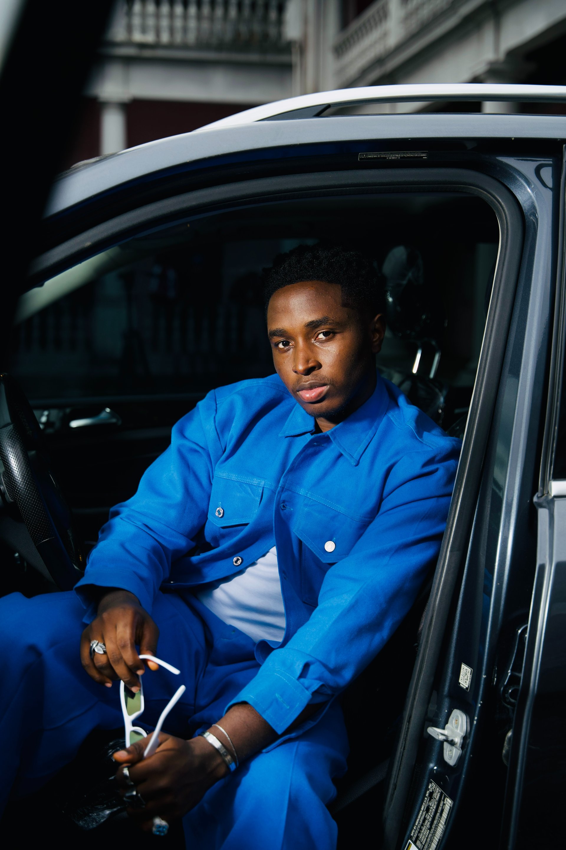 an abstract photo of a curved building with a blue sky in the background