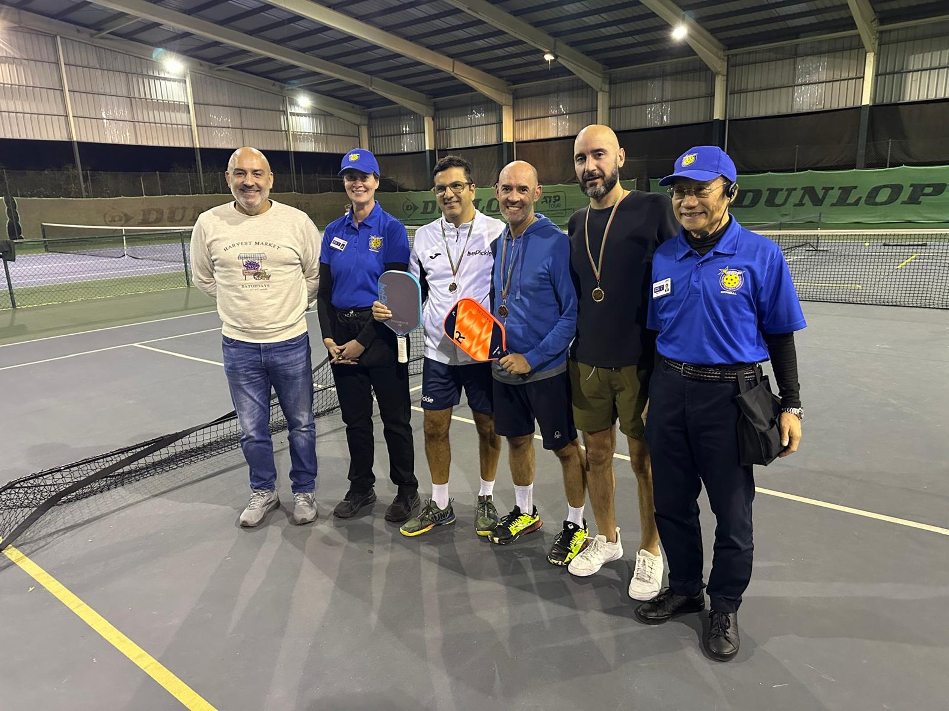 A person plays pickleball on a sunny day.