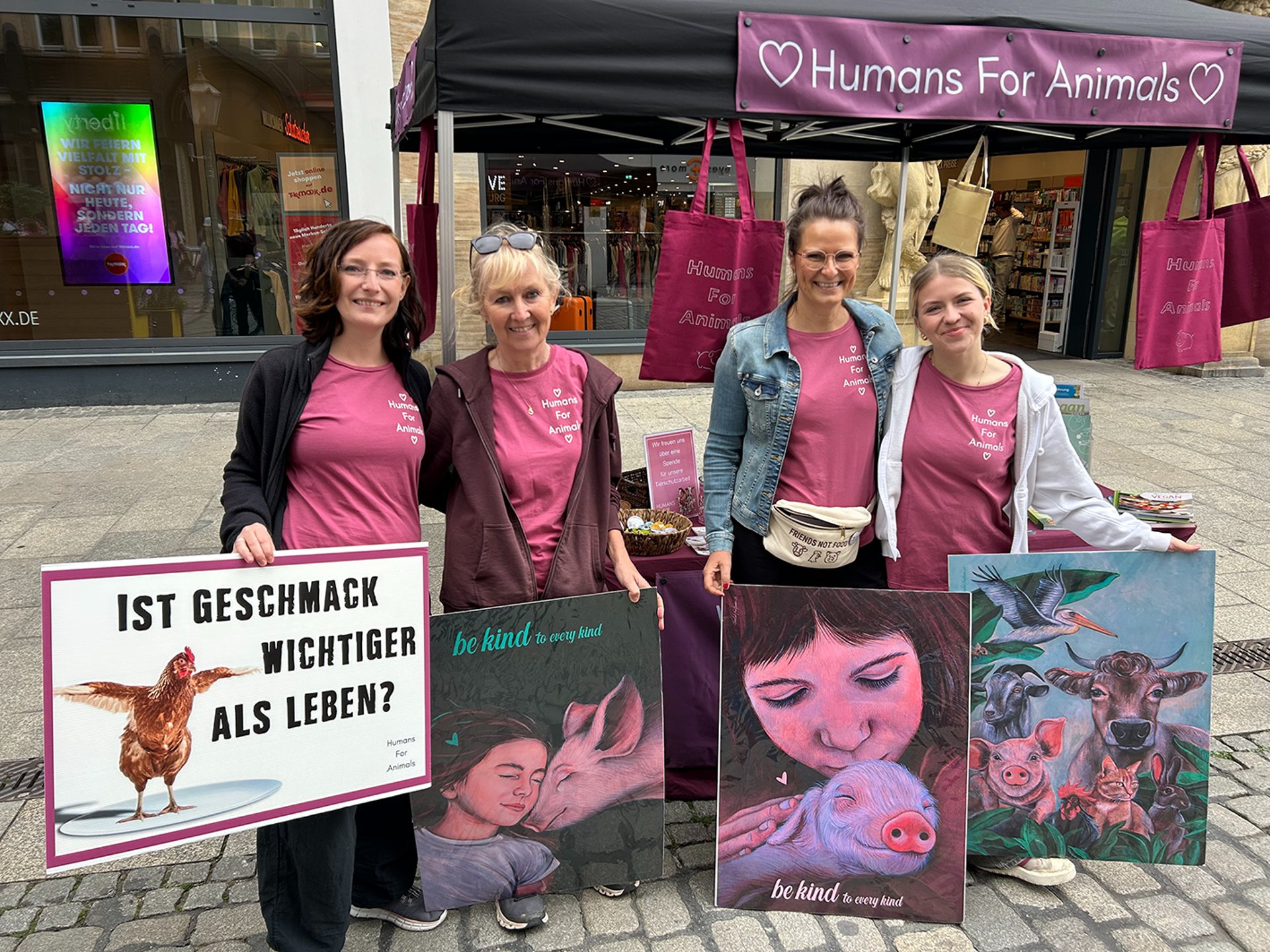 a herd of cows standing on top of a lush green field