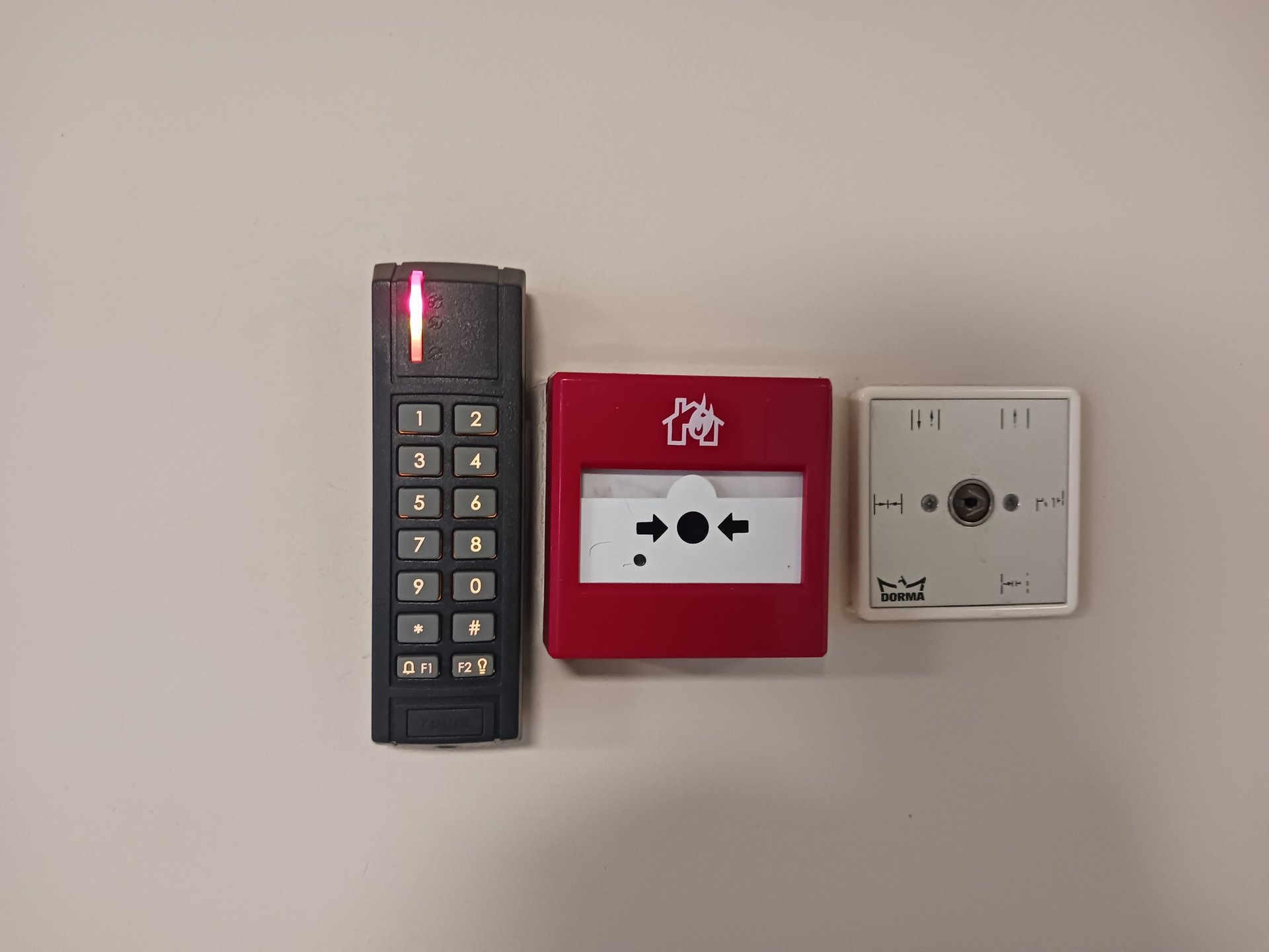red fire extinguisher on green wall