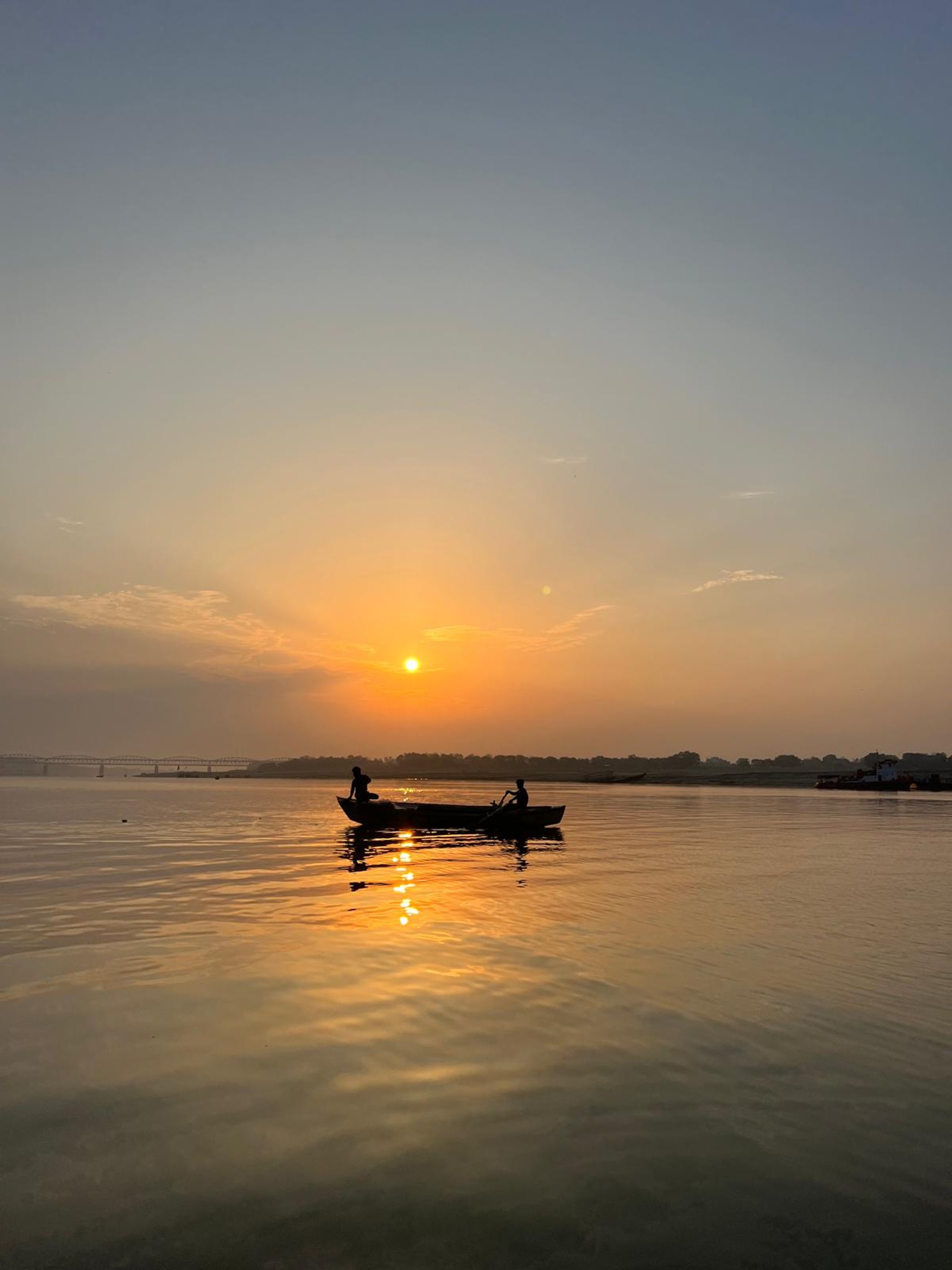 silhouette of people riding on boat during sunset