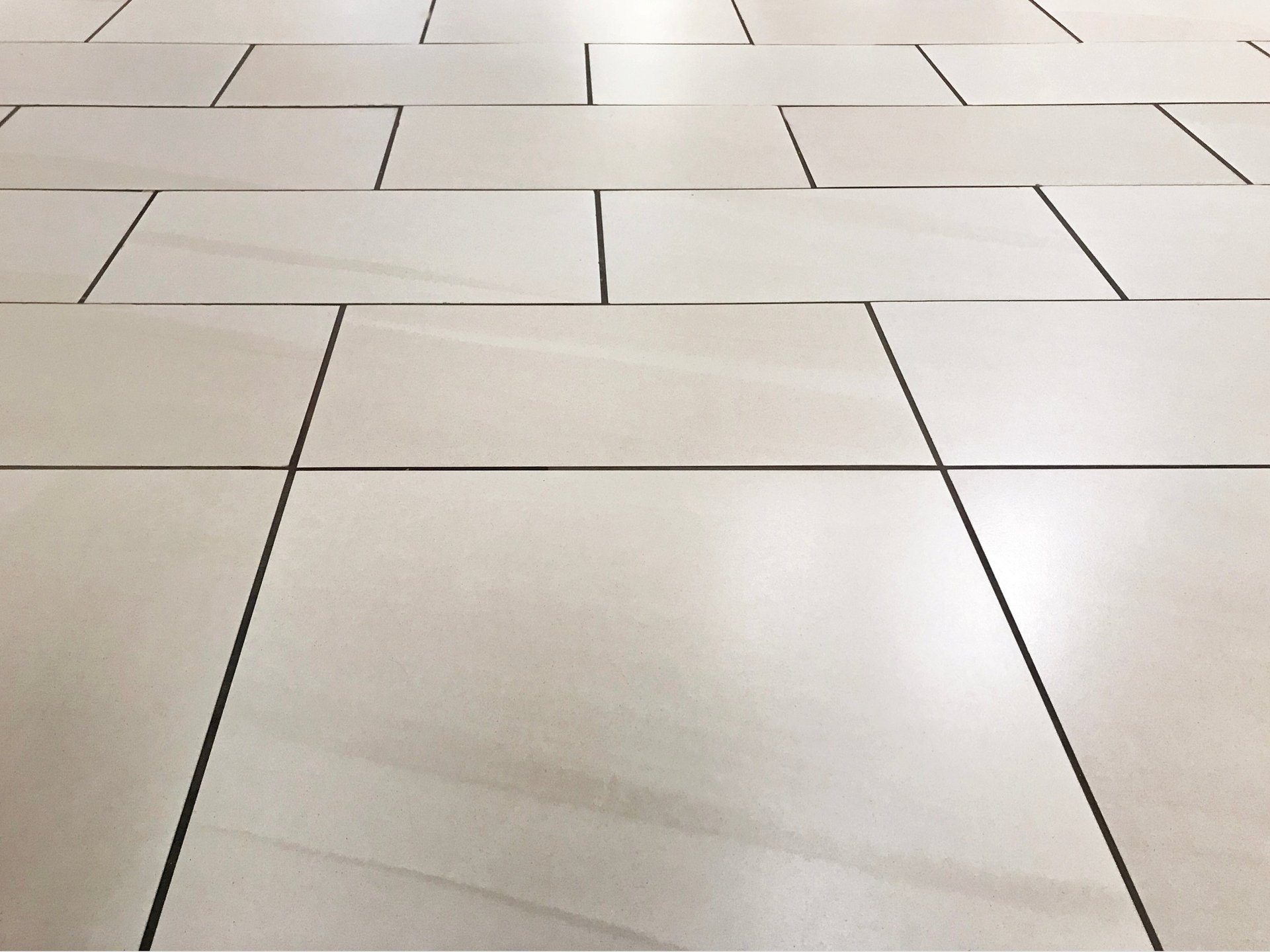 an abstract photo of a curved building with a blue sky in the background