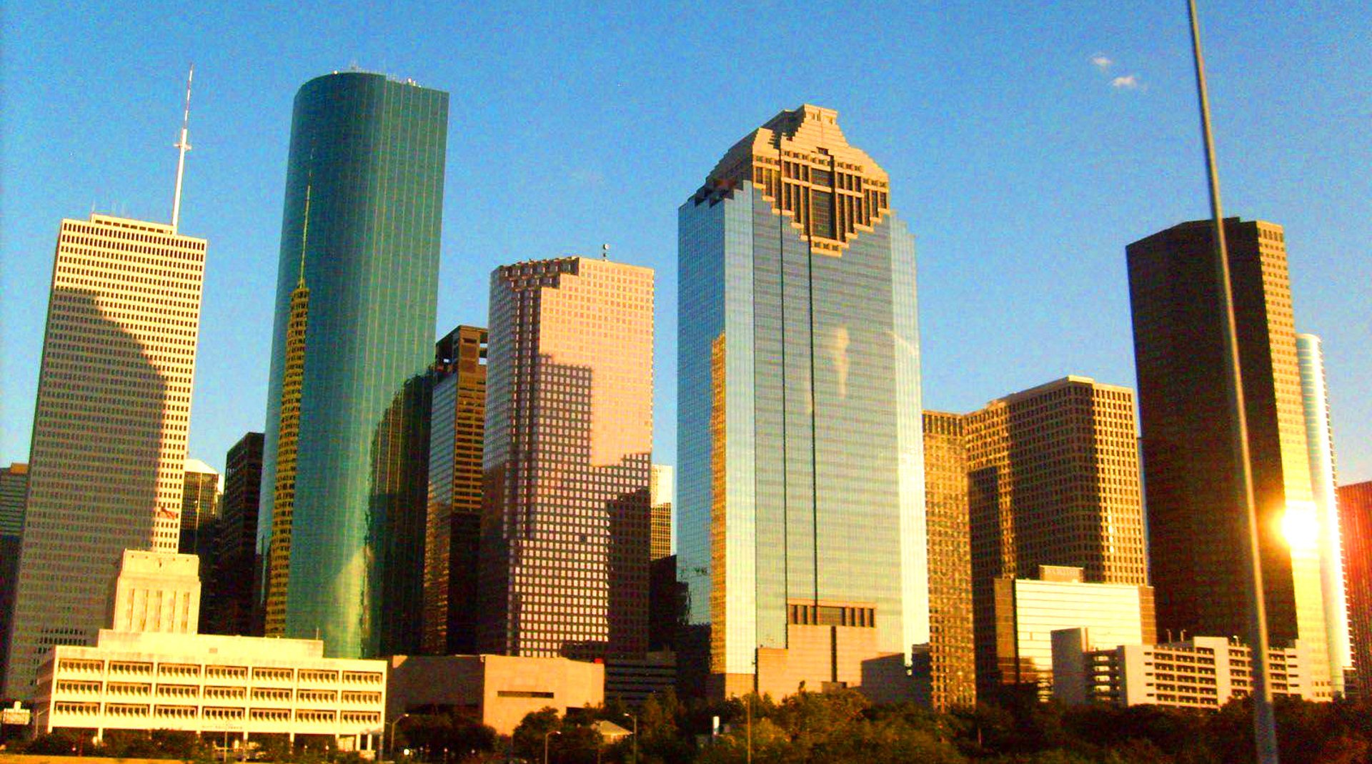 an abstract photo of a curved building with a blue sky in the background