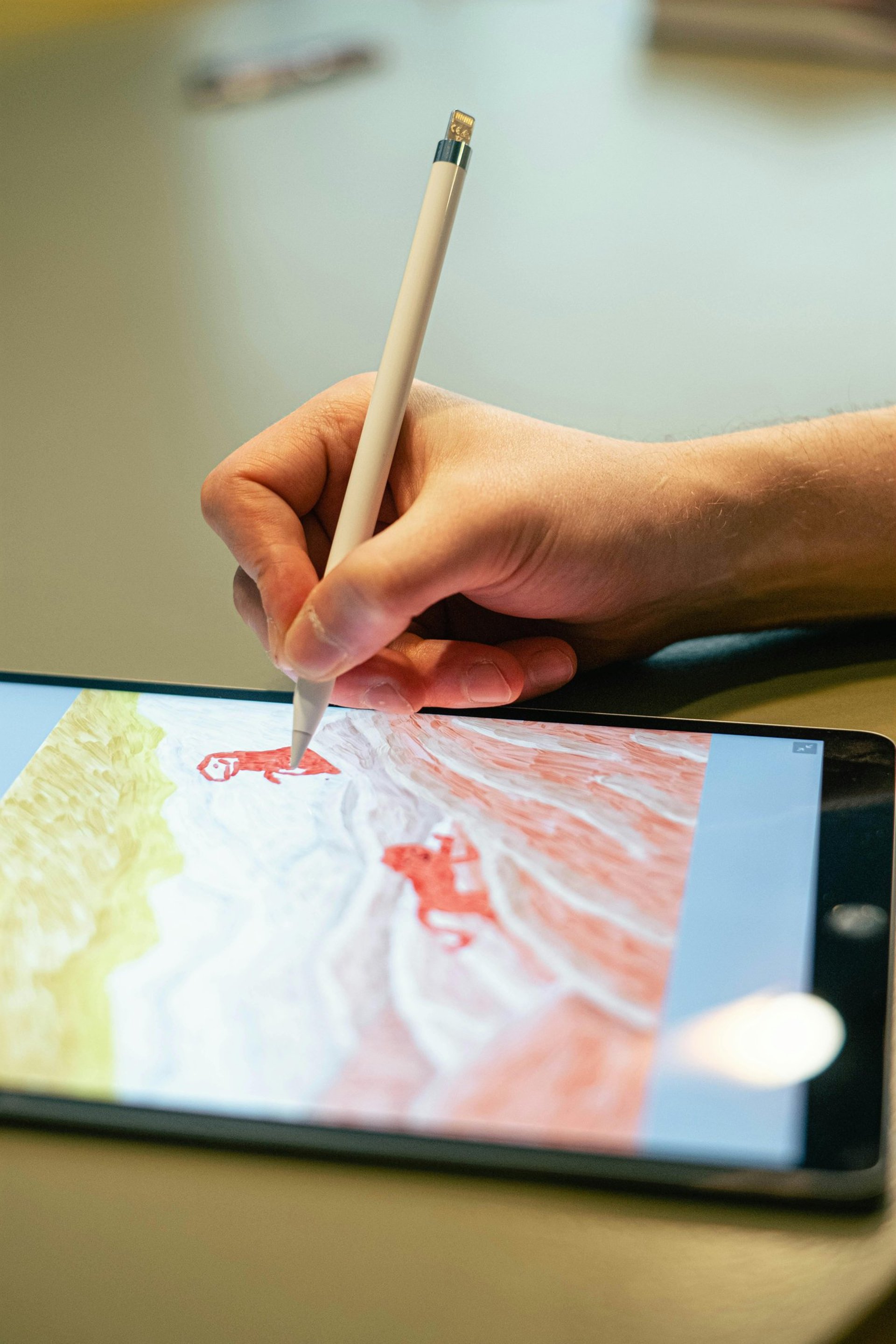 person holding white ipad with black case