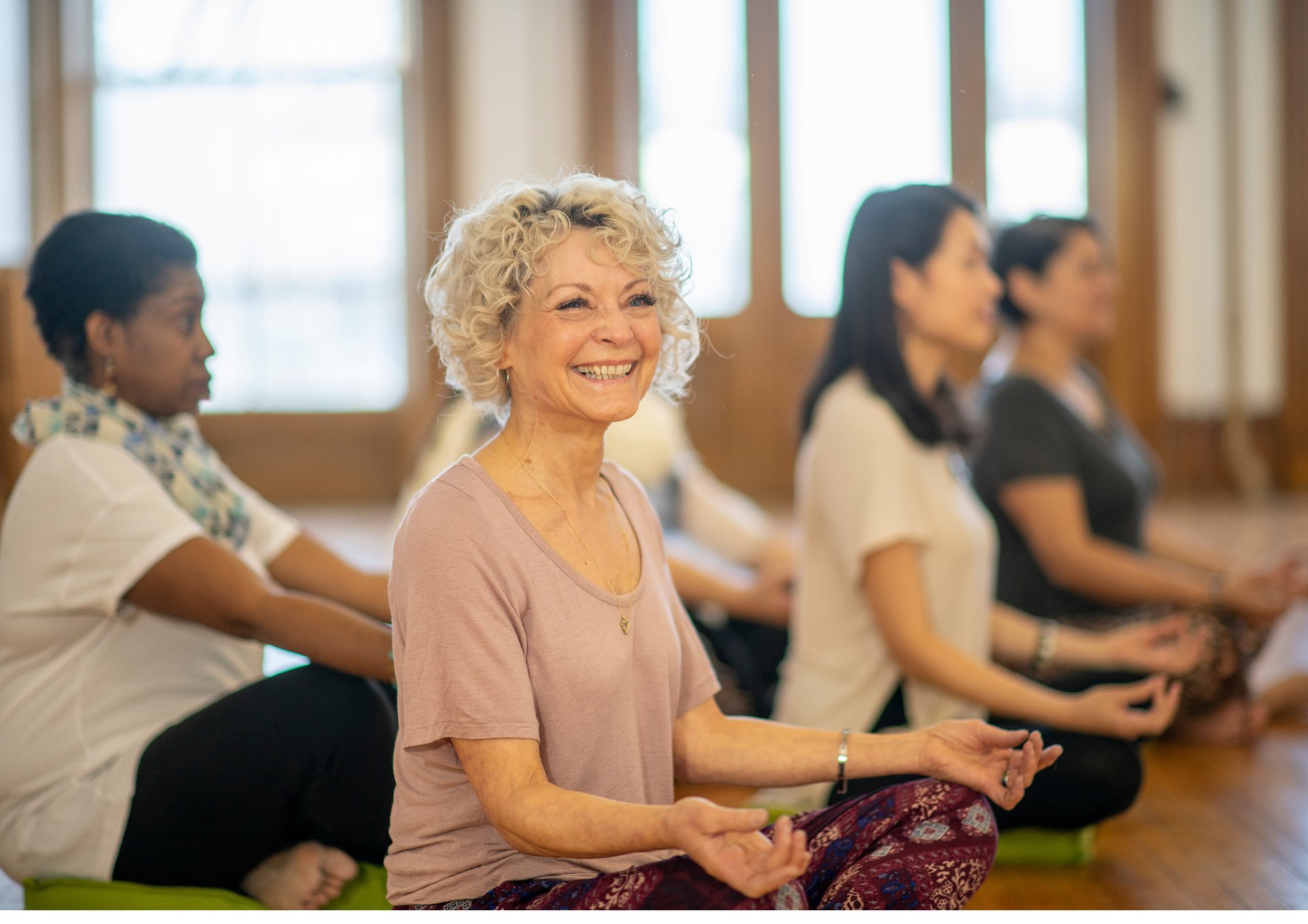 A group of people sitting on the ground doing yoga