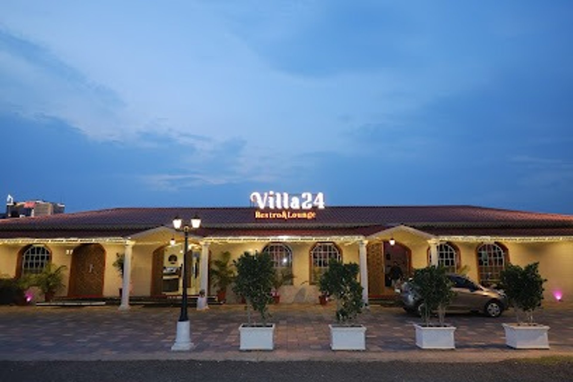 low-angle photo of Hotel lighted signage on top of brown building during nighttime
