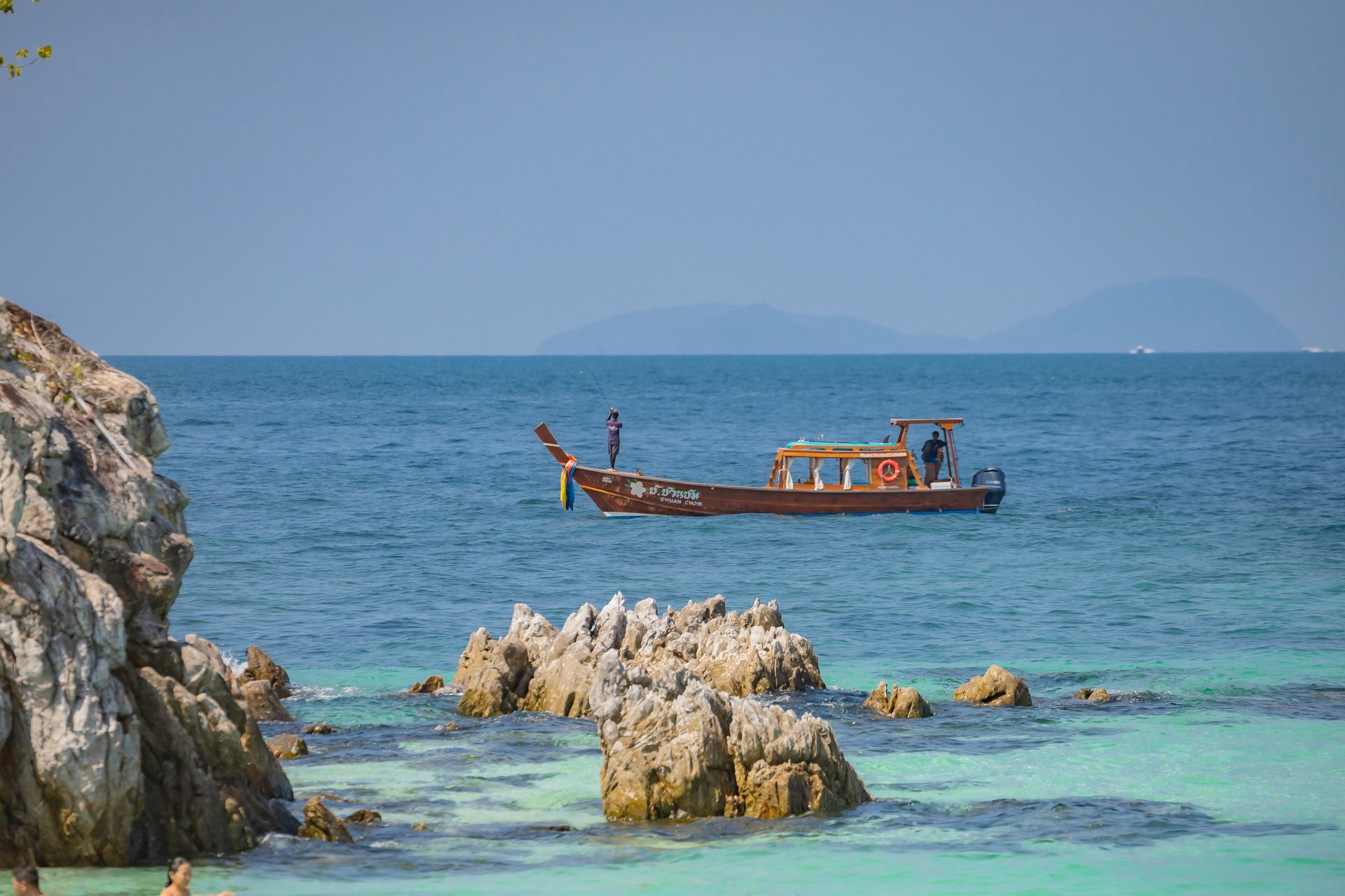a boat in the water near a beach