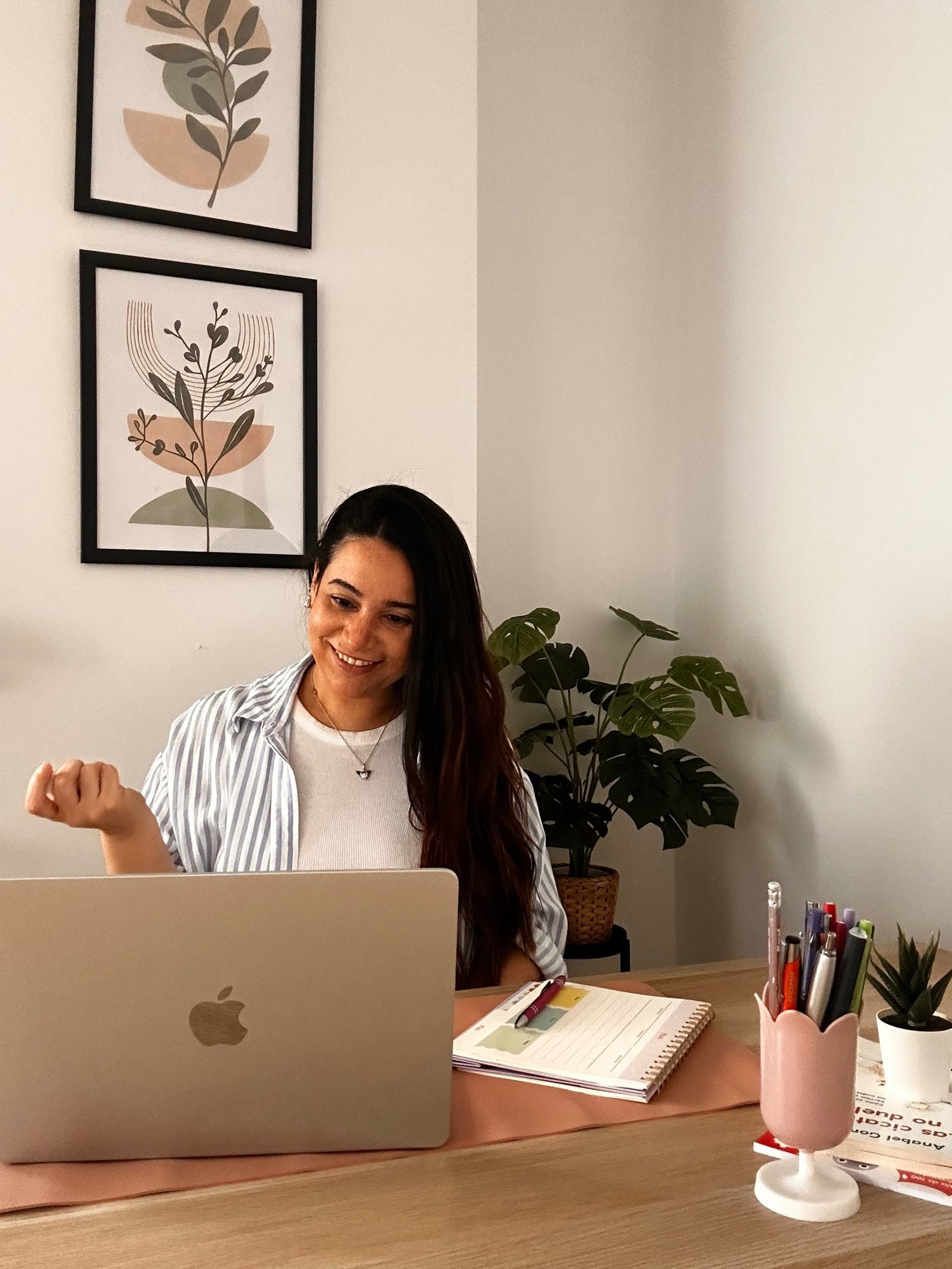 a woman sitting at a desk using a laptop computer