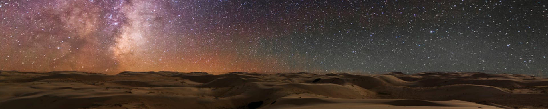 a sunset in the desert with trees in the foreground