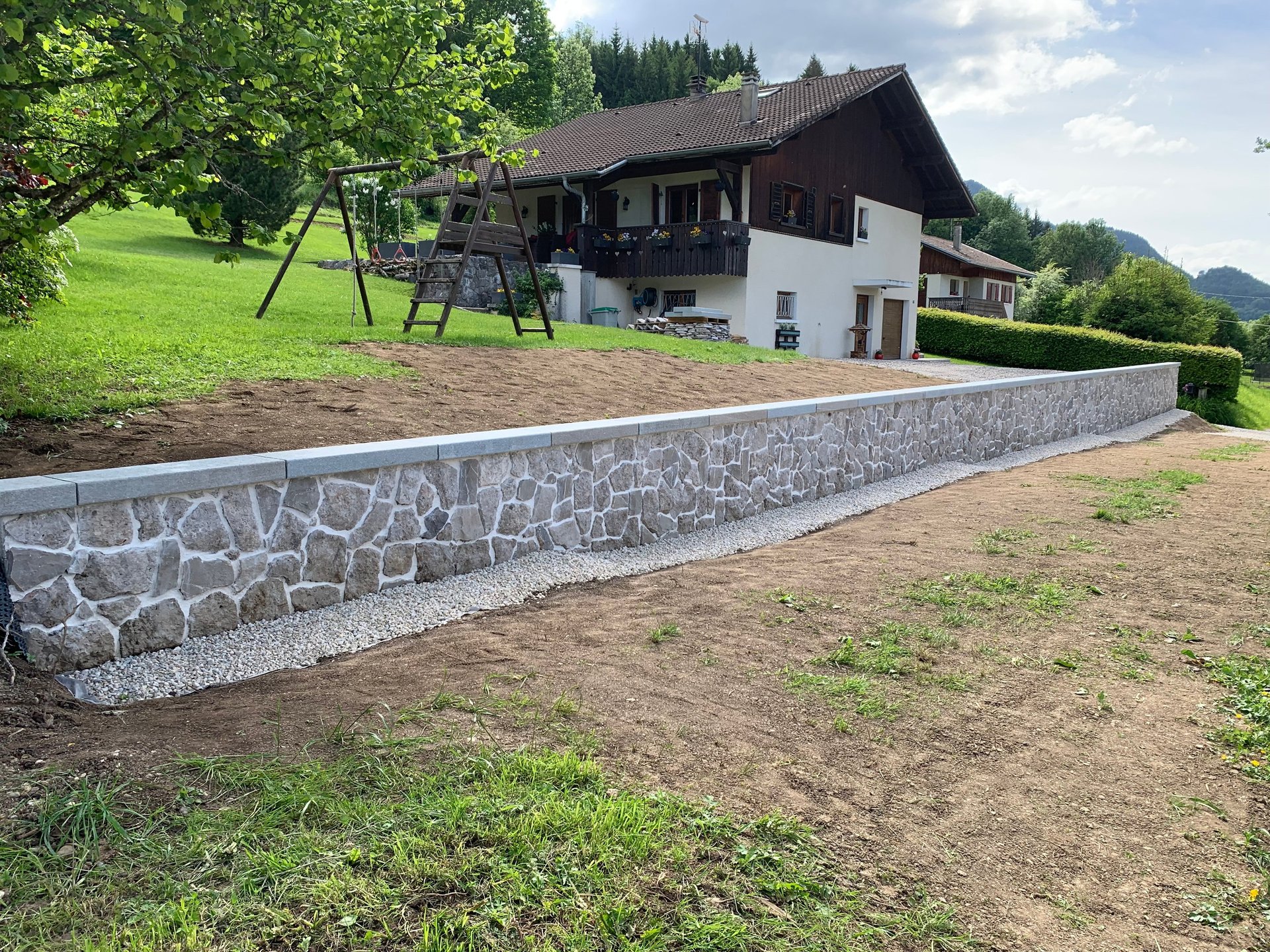 black and red 3M earmuffs beside miter saw